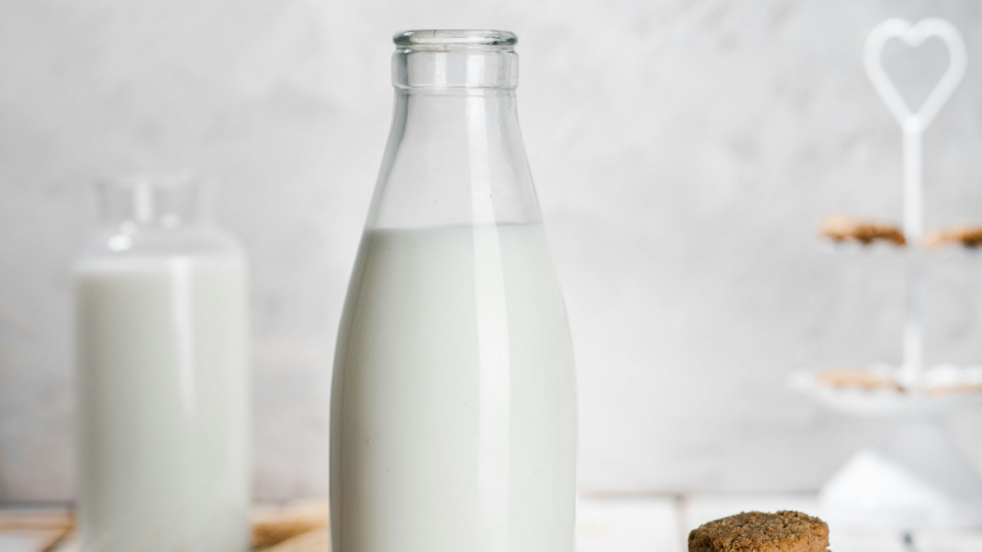 a bottle of milk and some cookies on a table