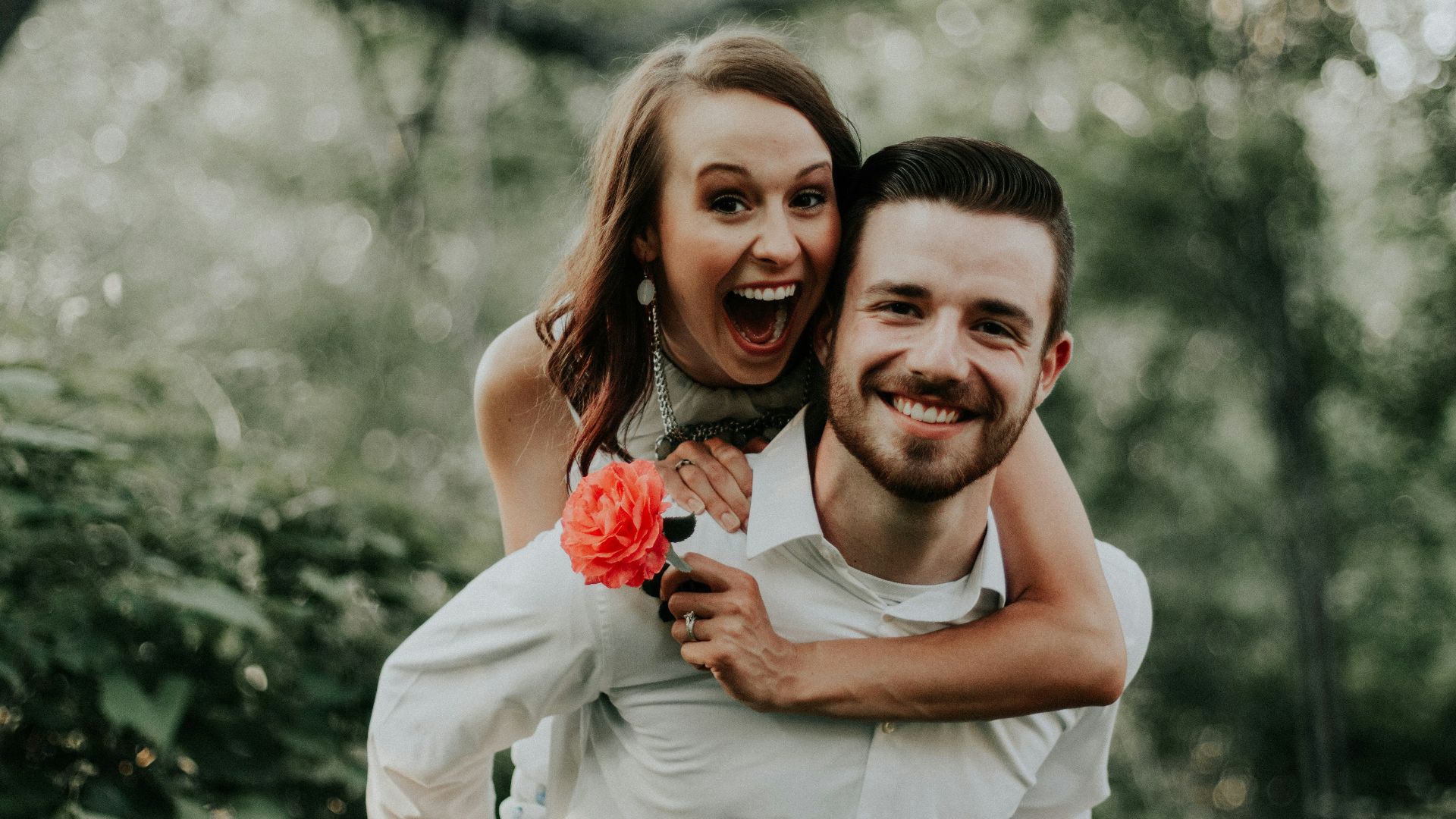 woman riding on back of man