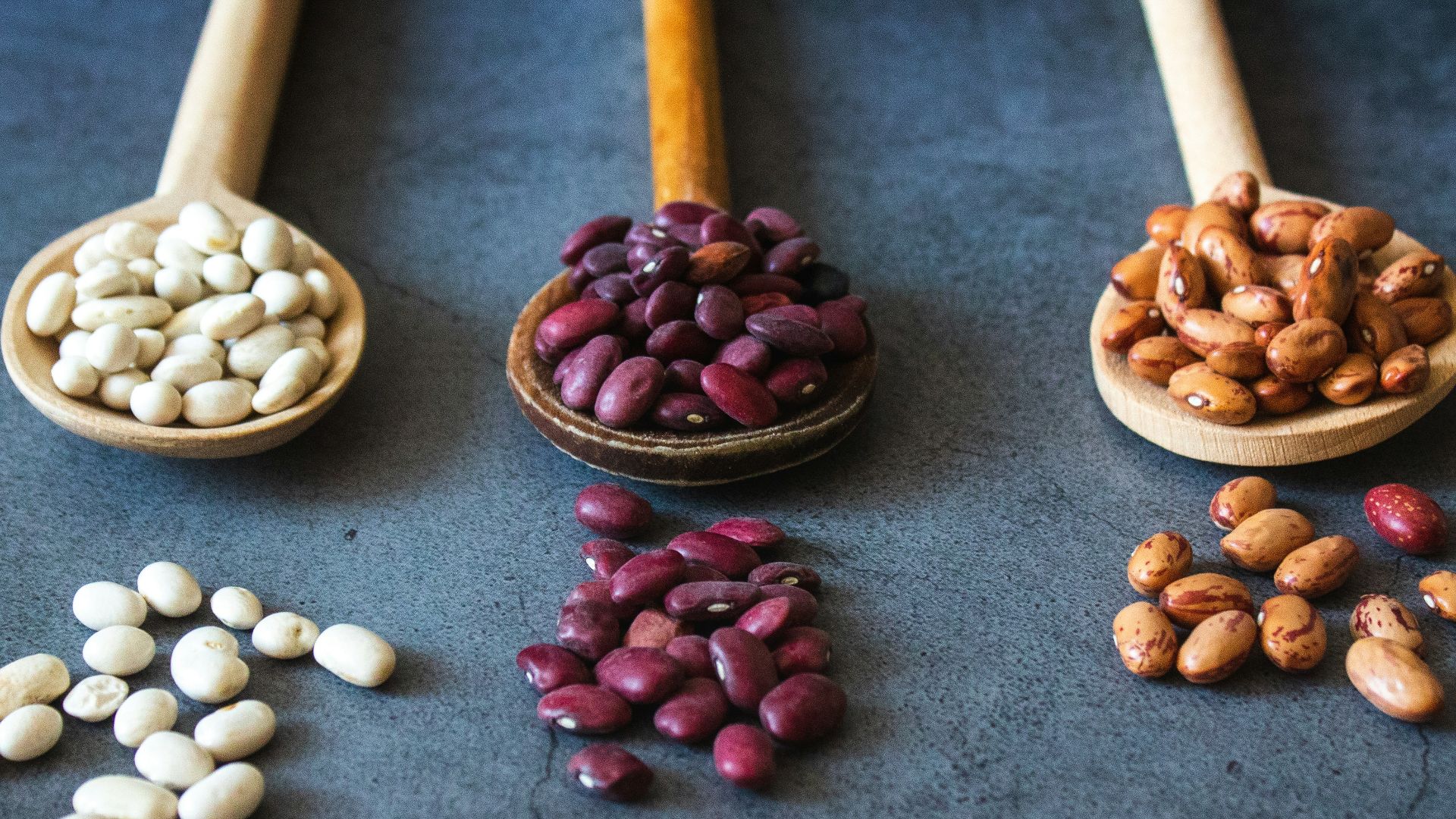 brown wooden spoon with red and brown beans