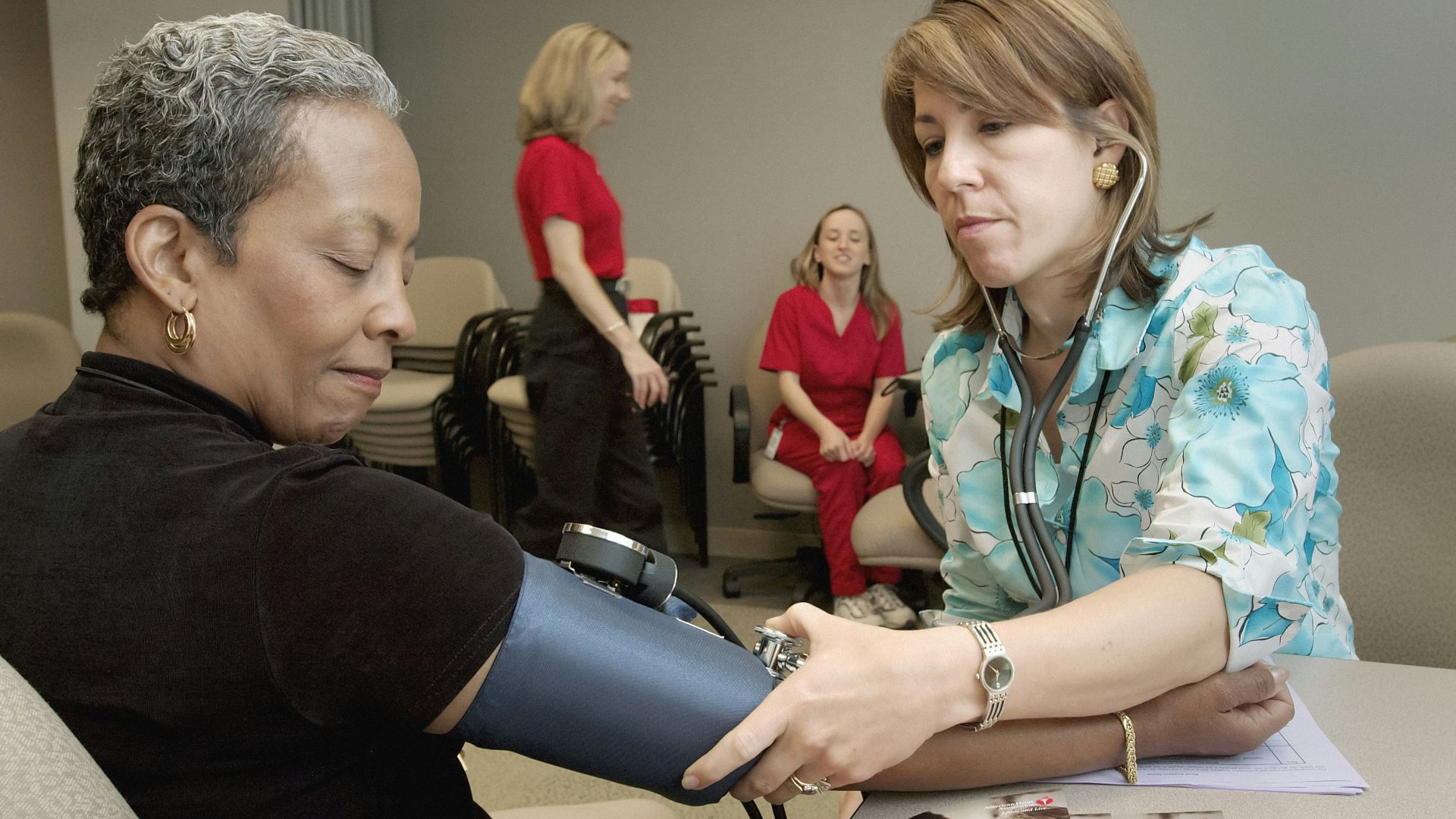 a woman with a stethoscope examines a woman's arm