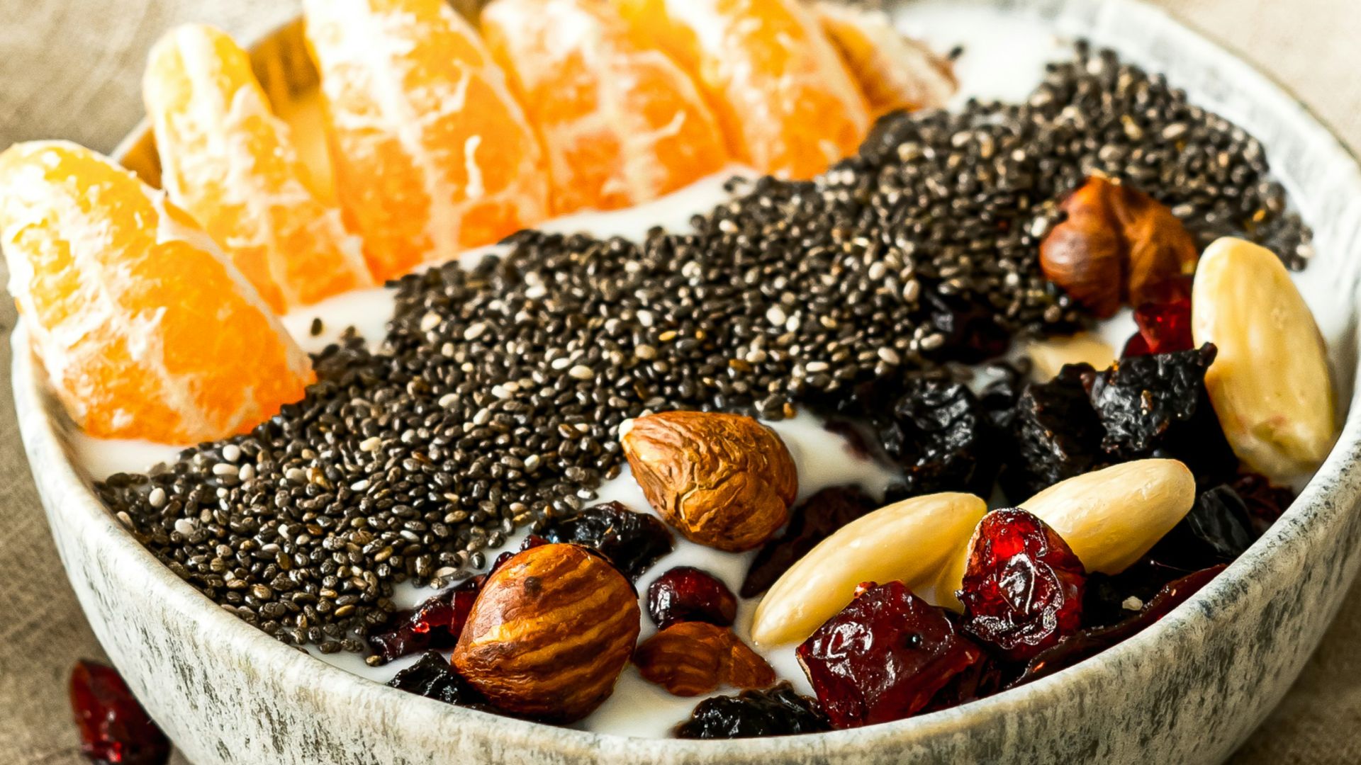a bowl filled with fruit and nuts on top of a table