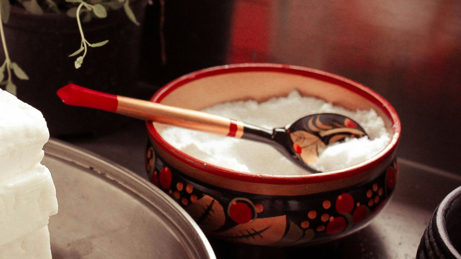red ceramic bowl on gray spoon