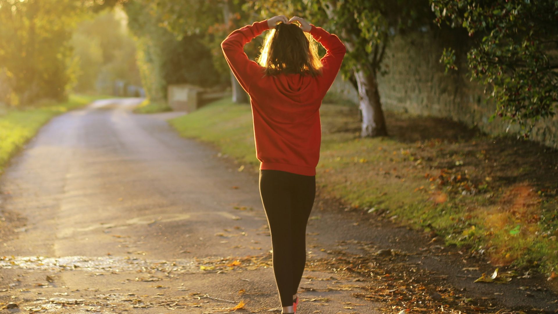 woman walking on pathway during daytime