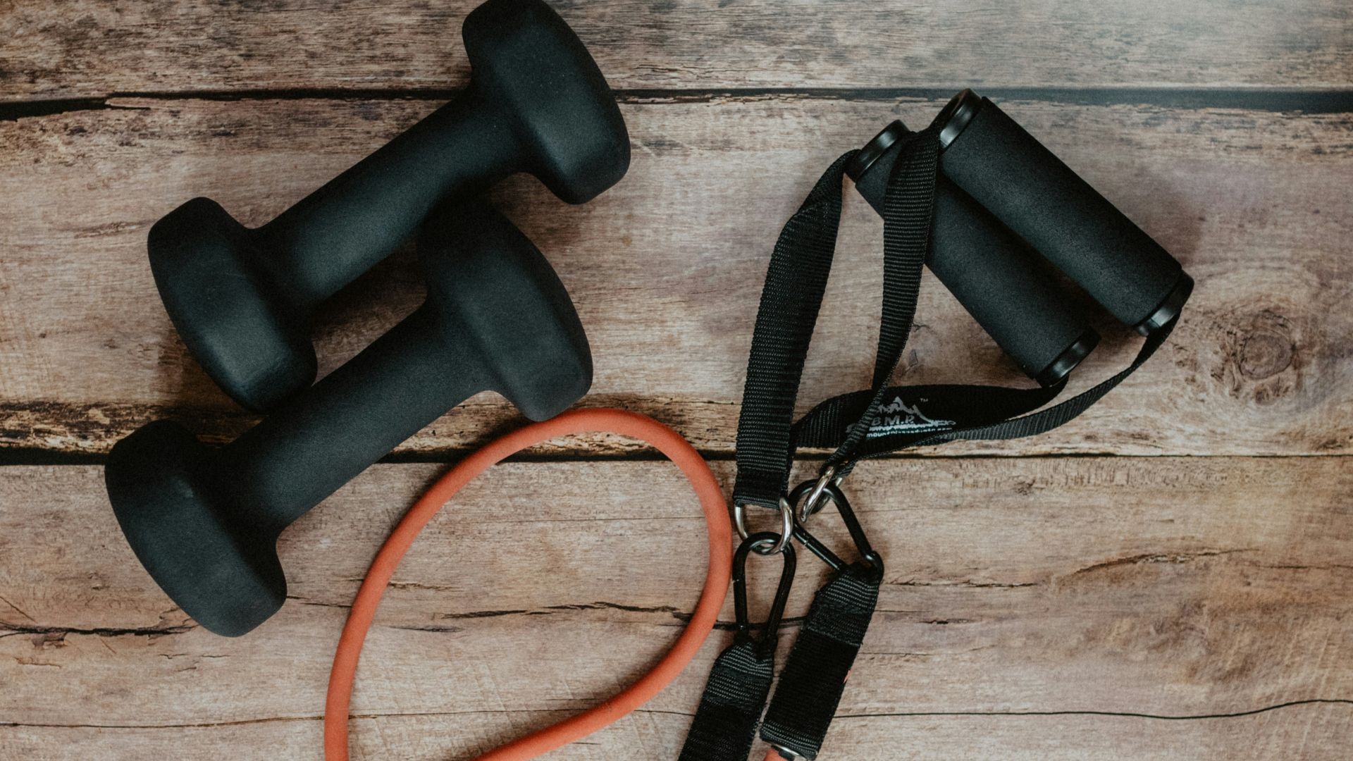 orange and black usb cable on brown wooden surface