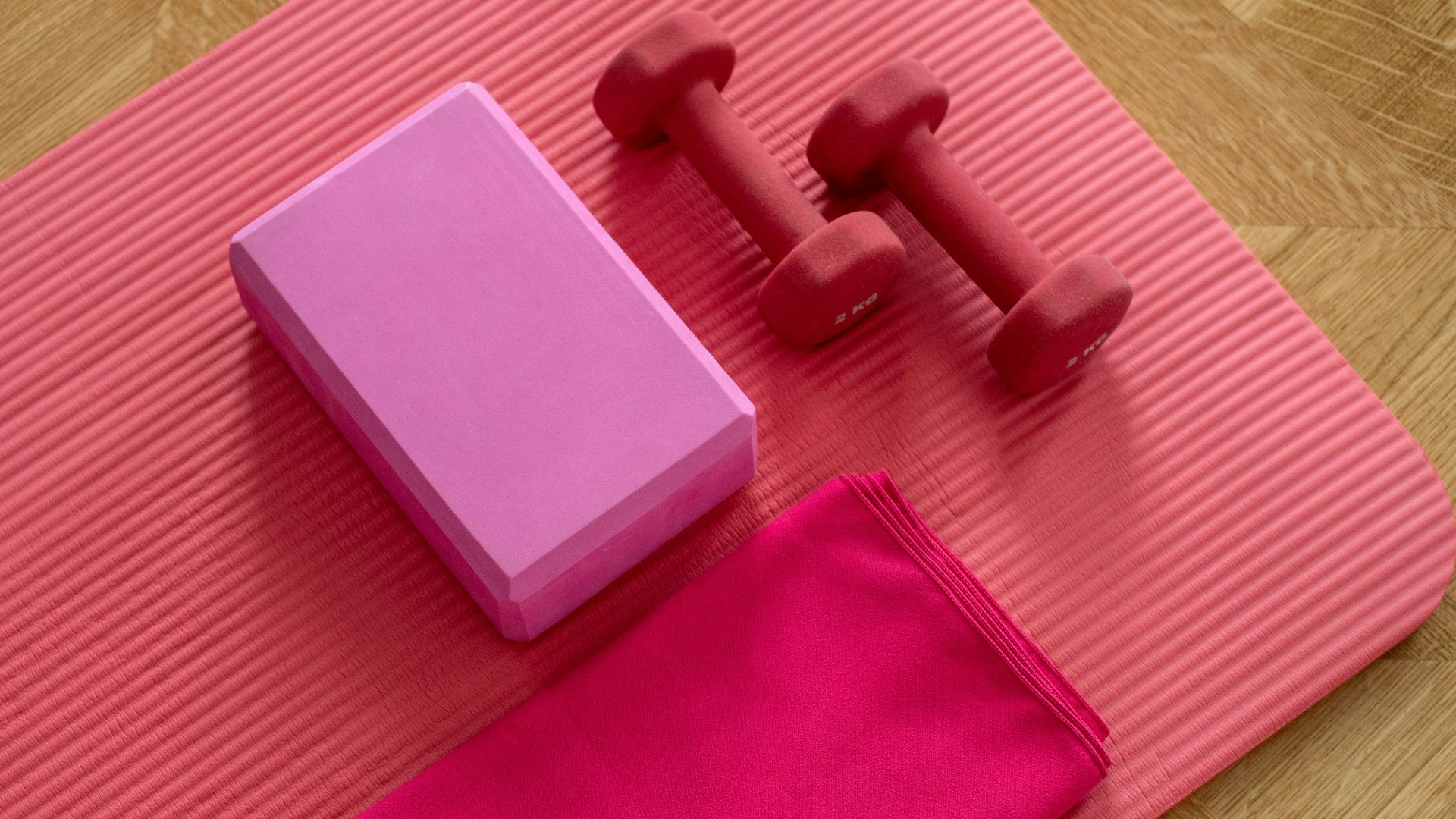 pink dumbbell on pink textile