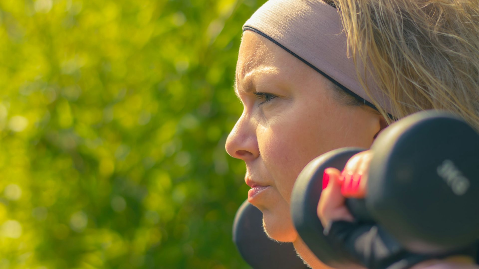 woman in white tank top with black headphones