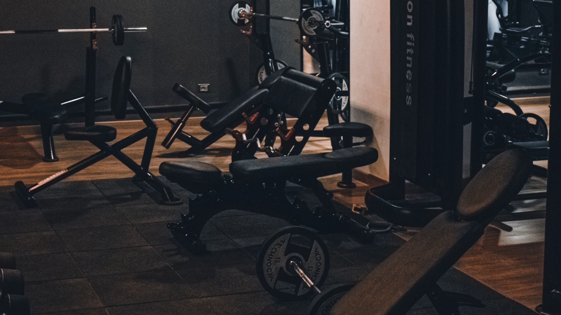 a gym with a row of exercise machines