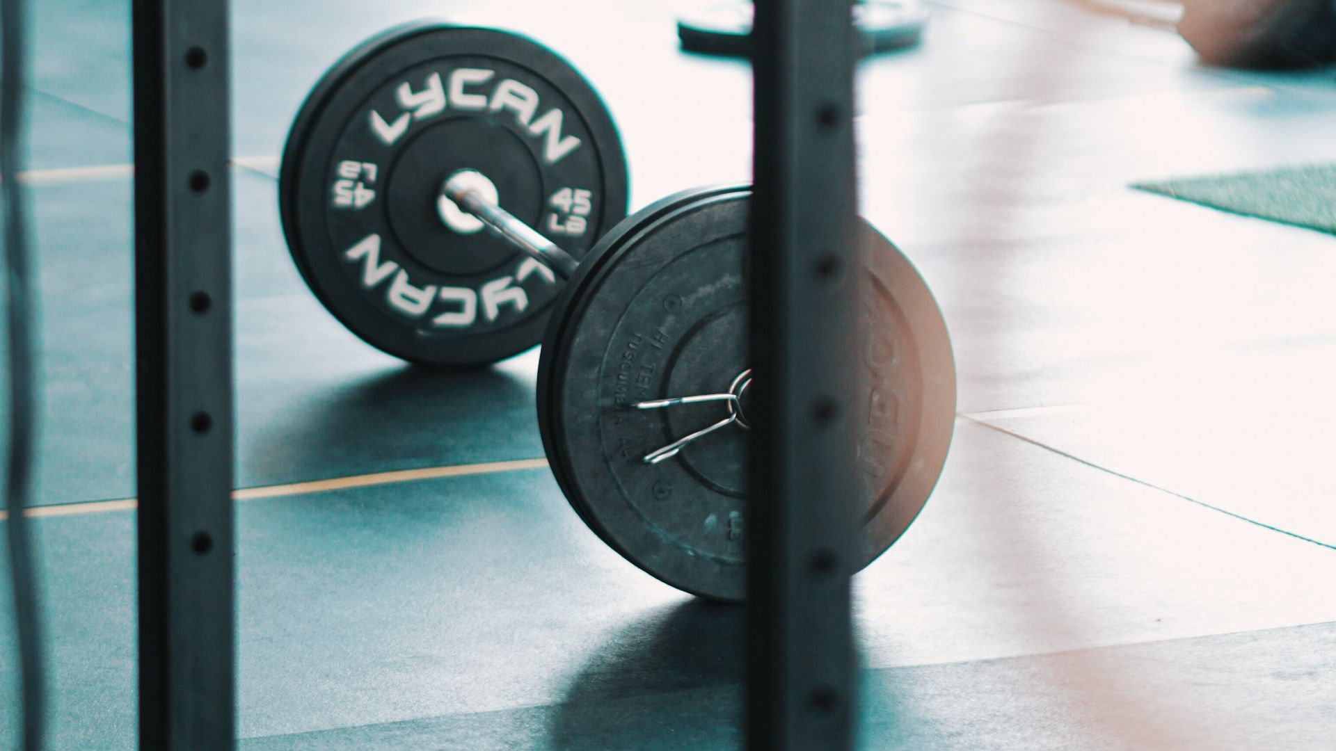 a gym with a barbell and weight plates