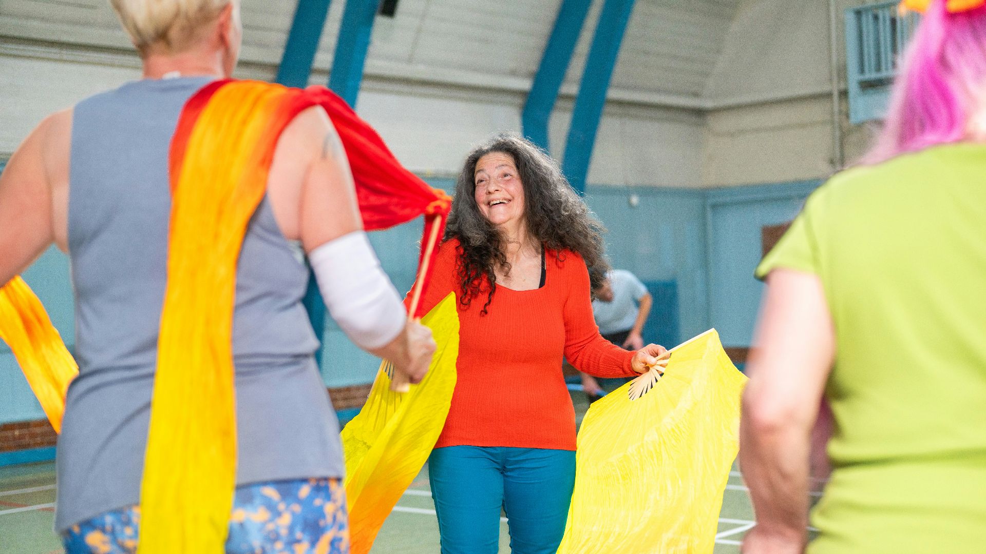 Women dancing with colorful flowing fabric