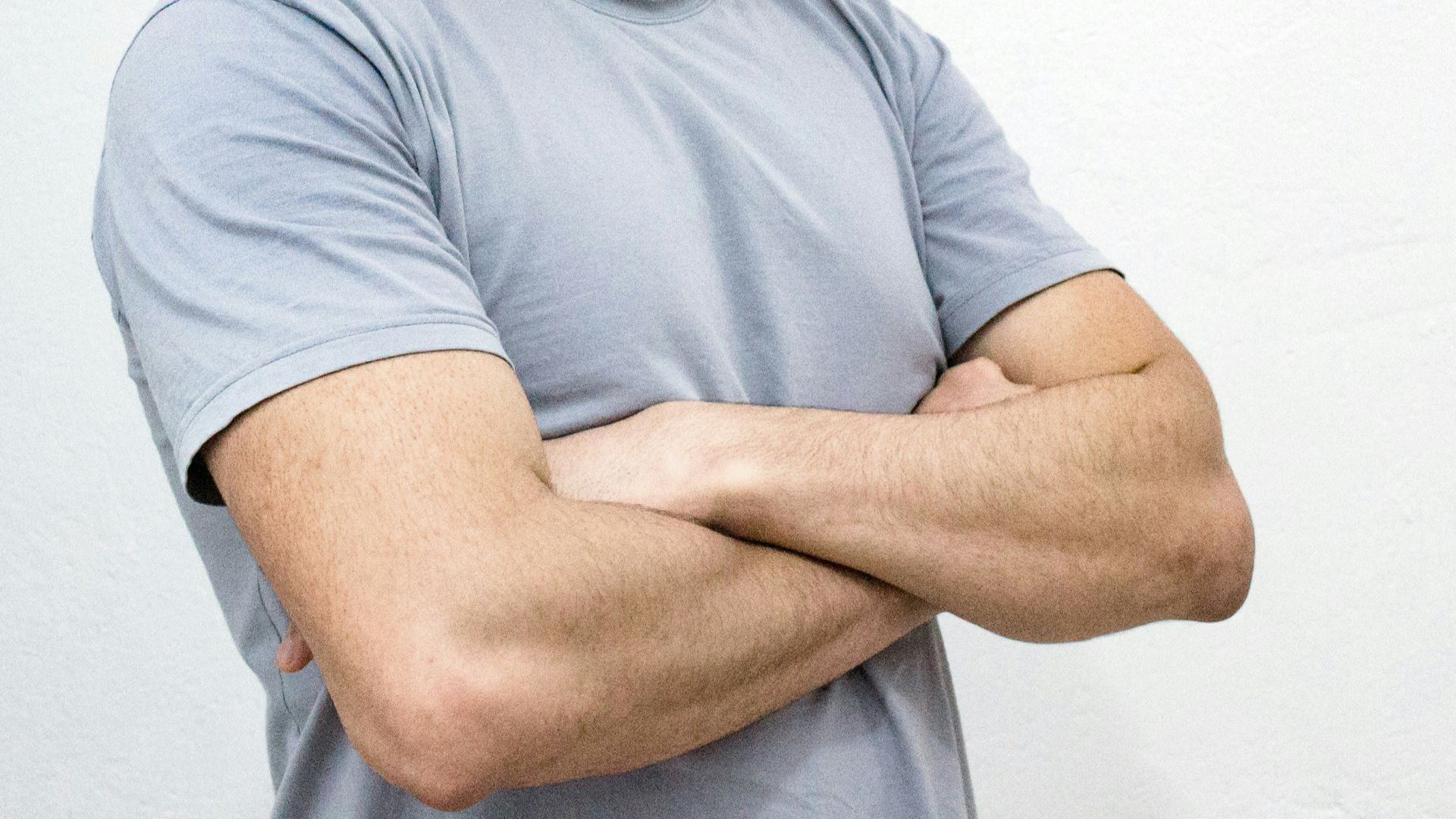 man crossing both arms