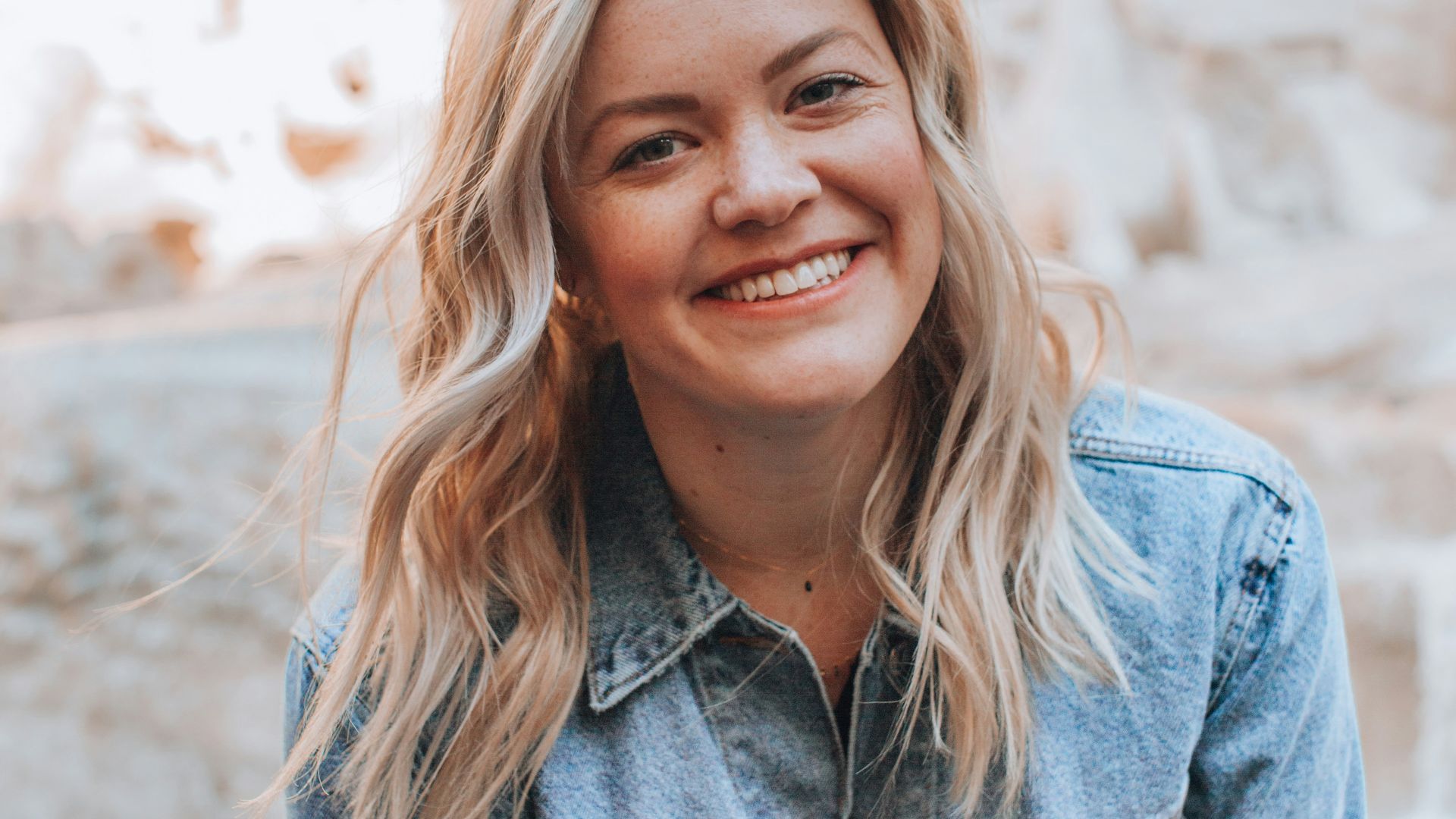 woman smiling wearing denim jacket