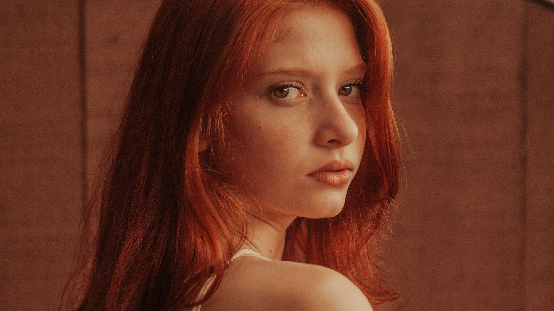 selective focus photography of woman with brown wooden wall background