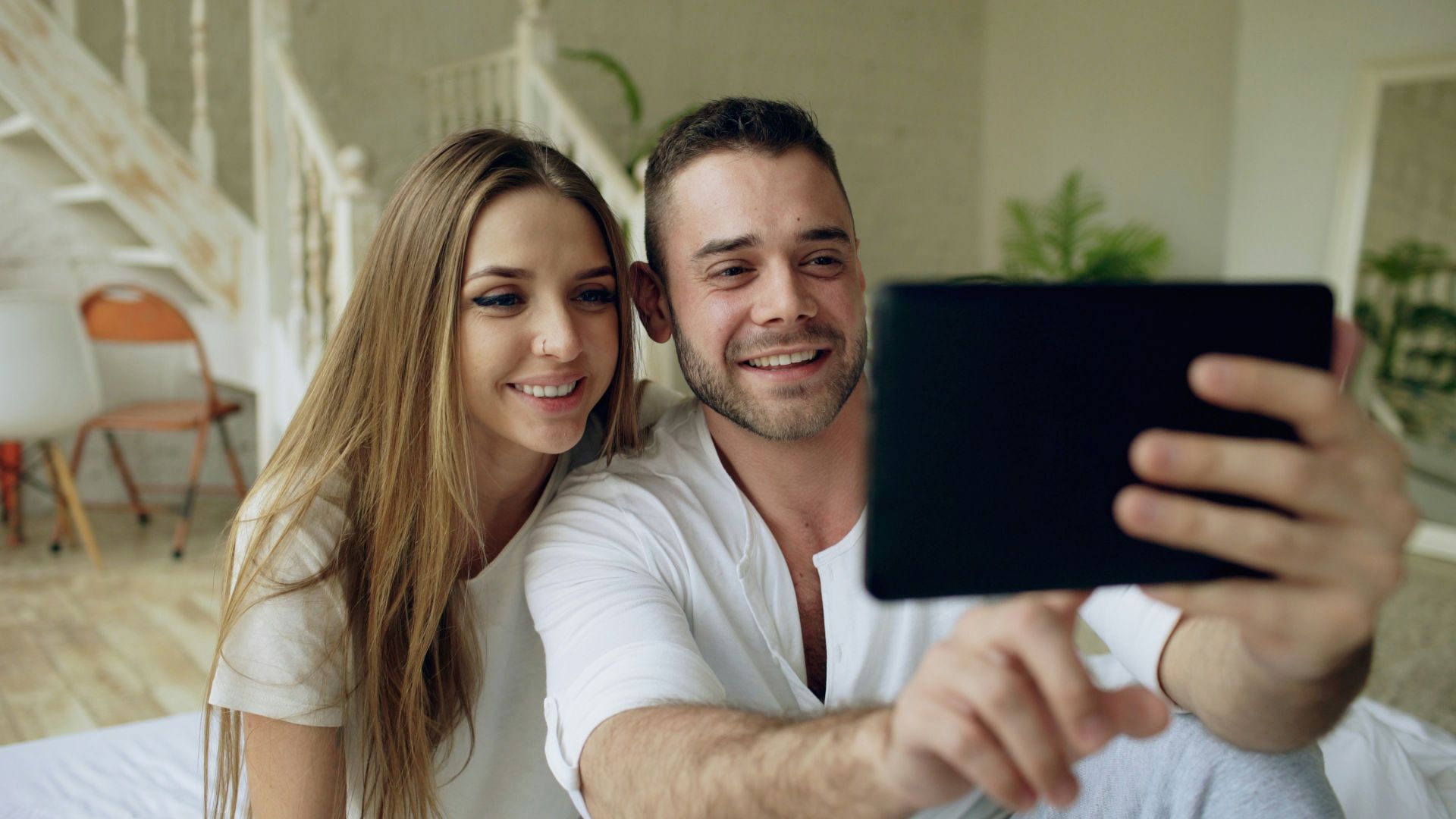 Couple taking a selfie with a tablet