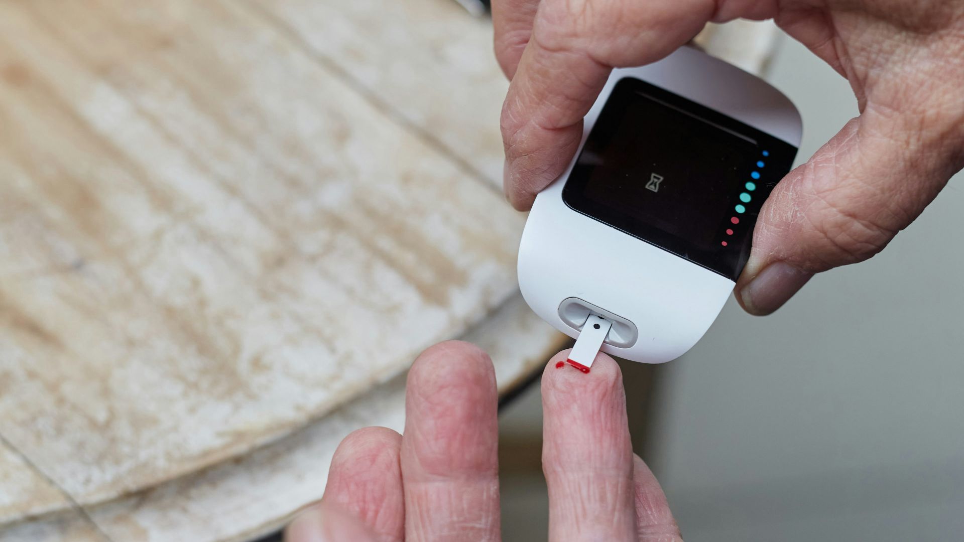 a person blood sugar testing using a gluco-meter