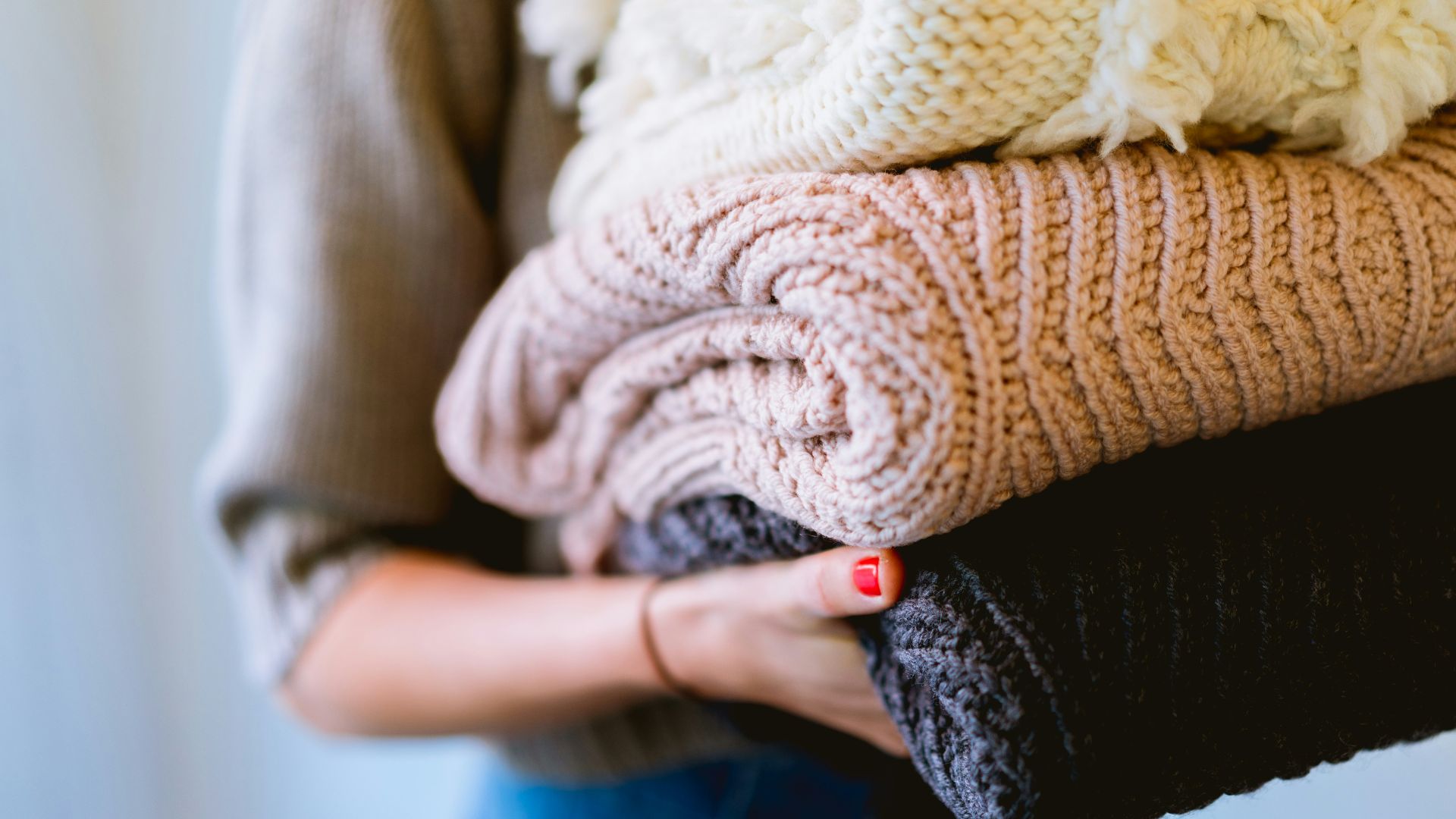 person holding knitted textiles