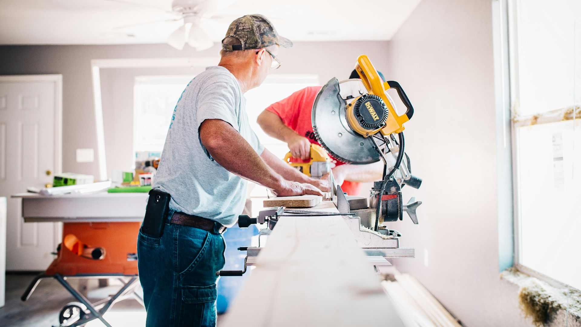 man standing infront of miter saw