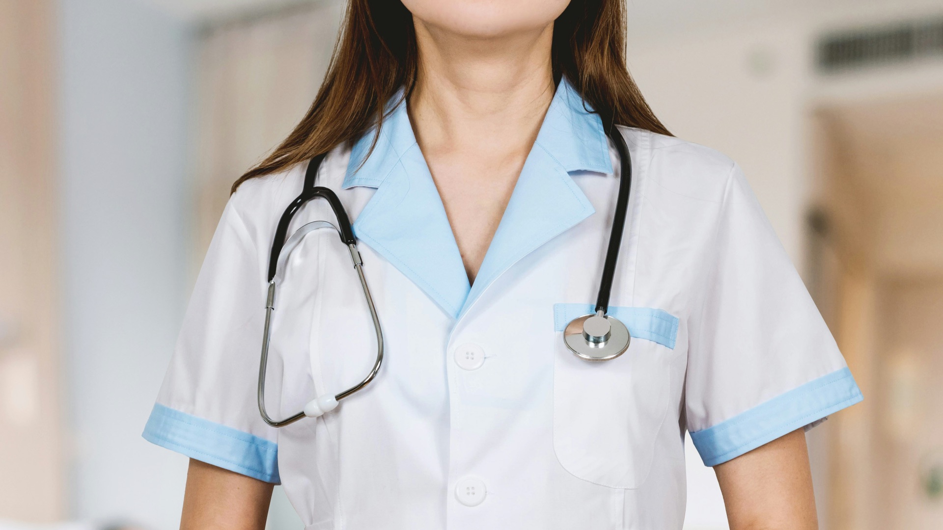 woman in white button up shirt and blue stethoscope