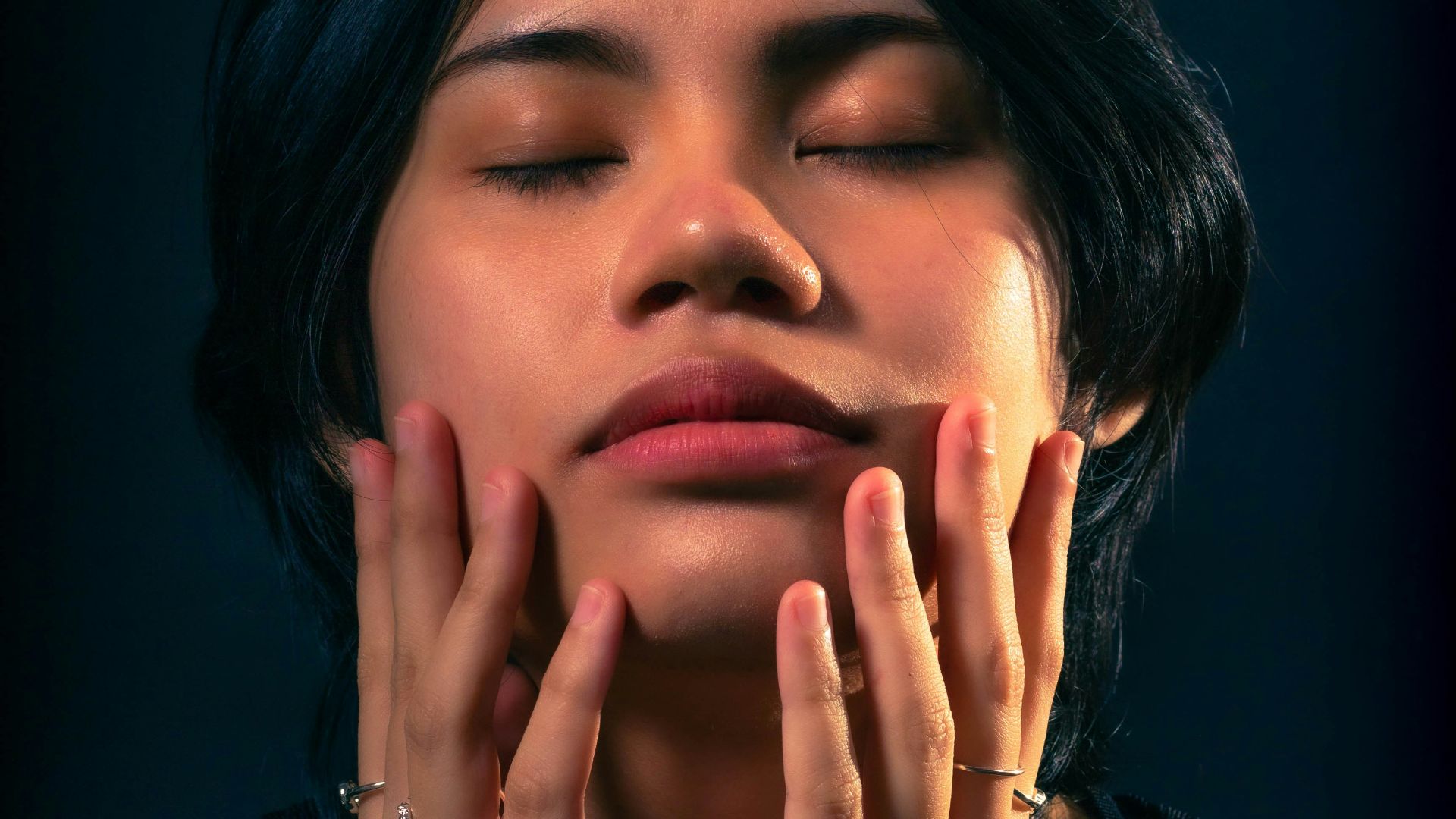 a woman with her hands on her face
