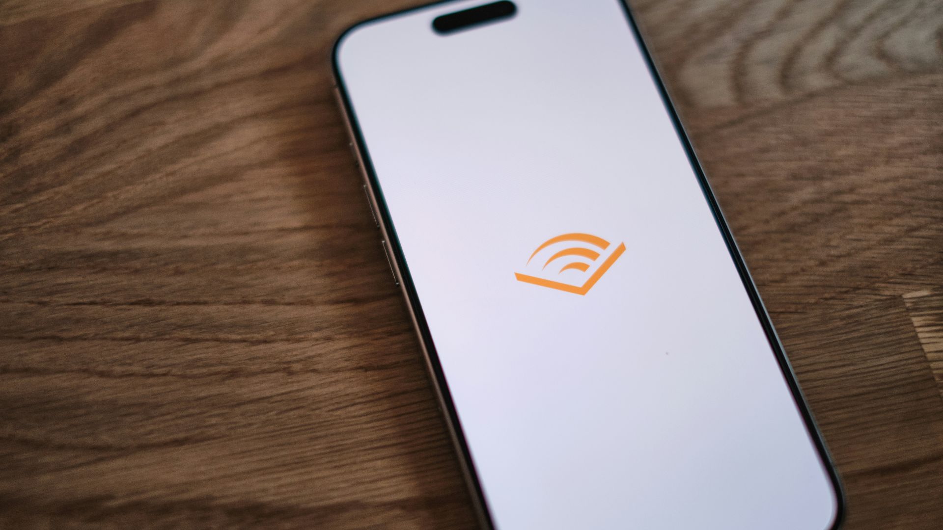 A cell phone sitting on top of a wooden table