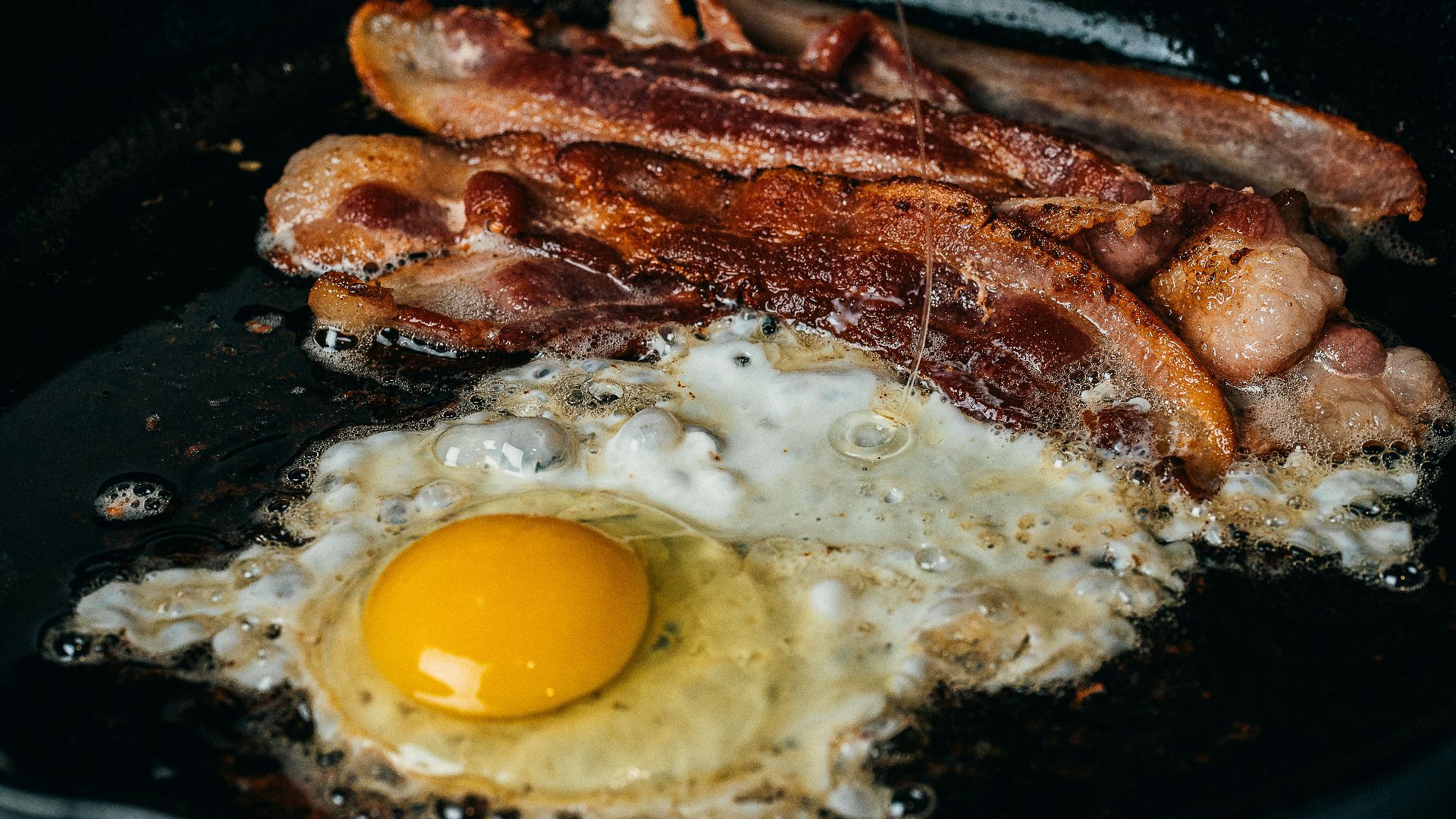fried egg on black pan