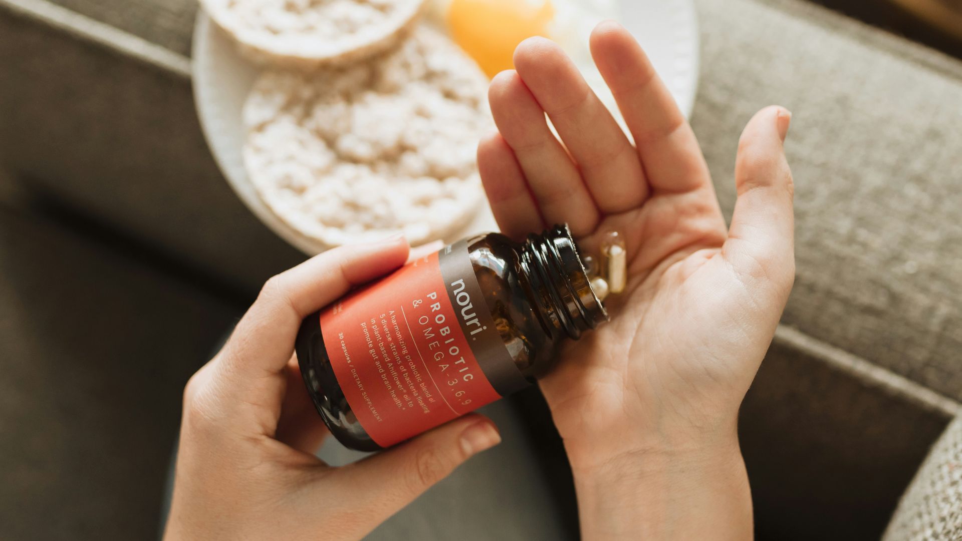 person holding red bottle