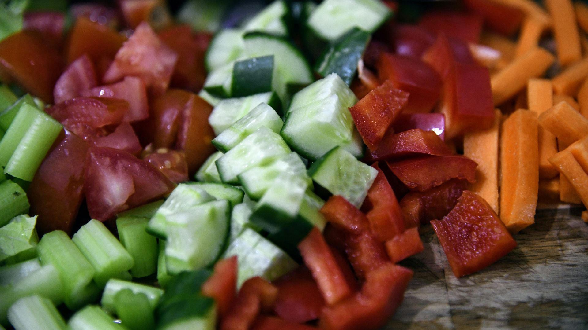 a close up of a cutting board with chopped vegetables