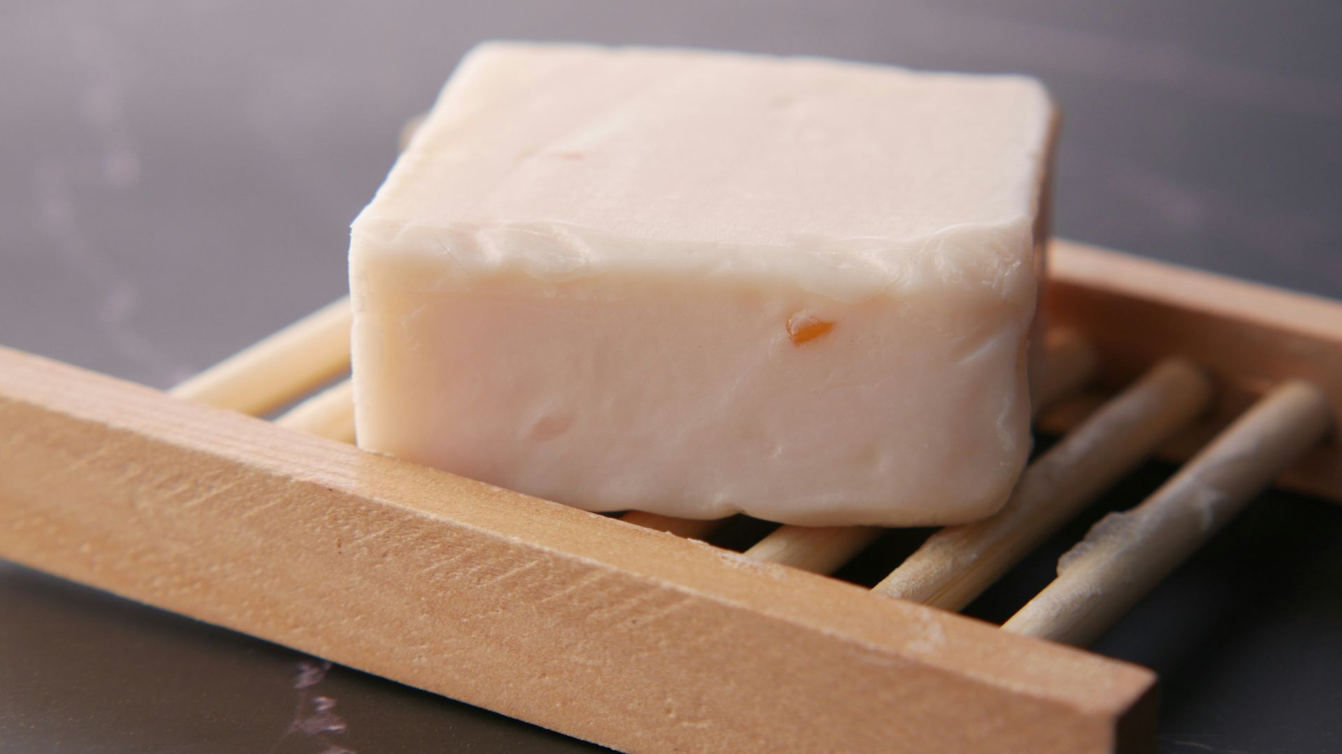 a block of soap sitting on top of chopsticks