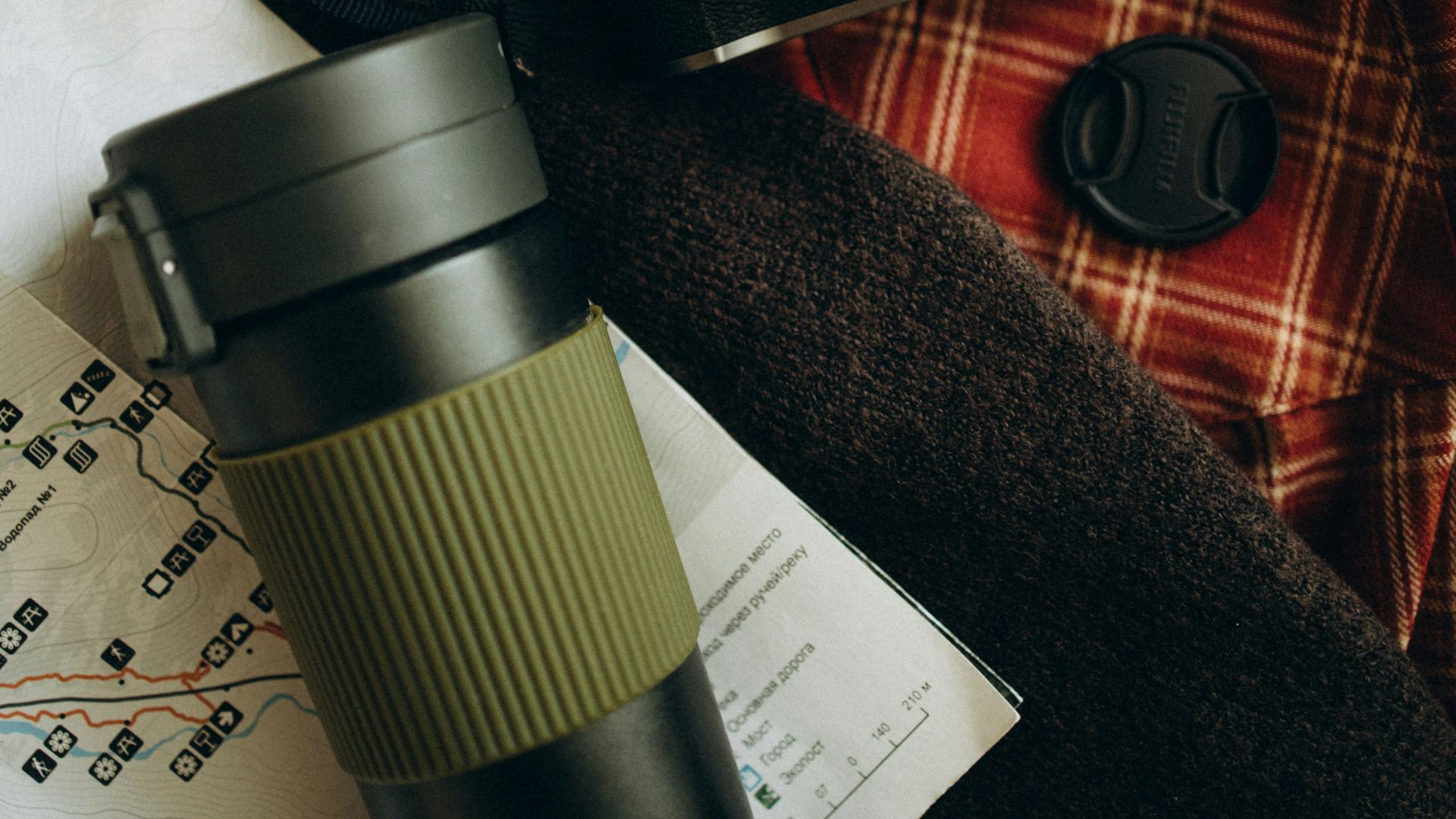 Camera, thermos, and map for travel adventure