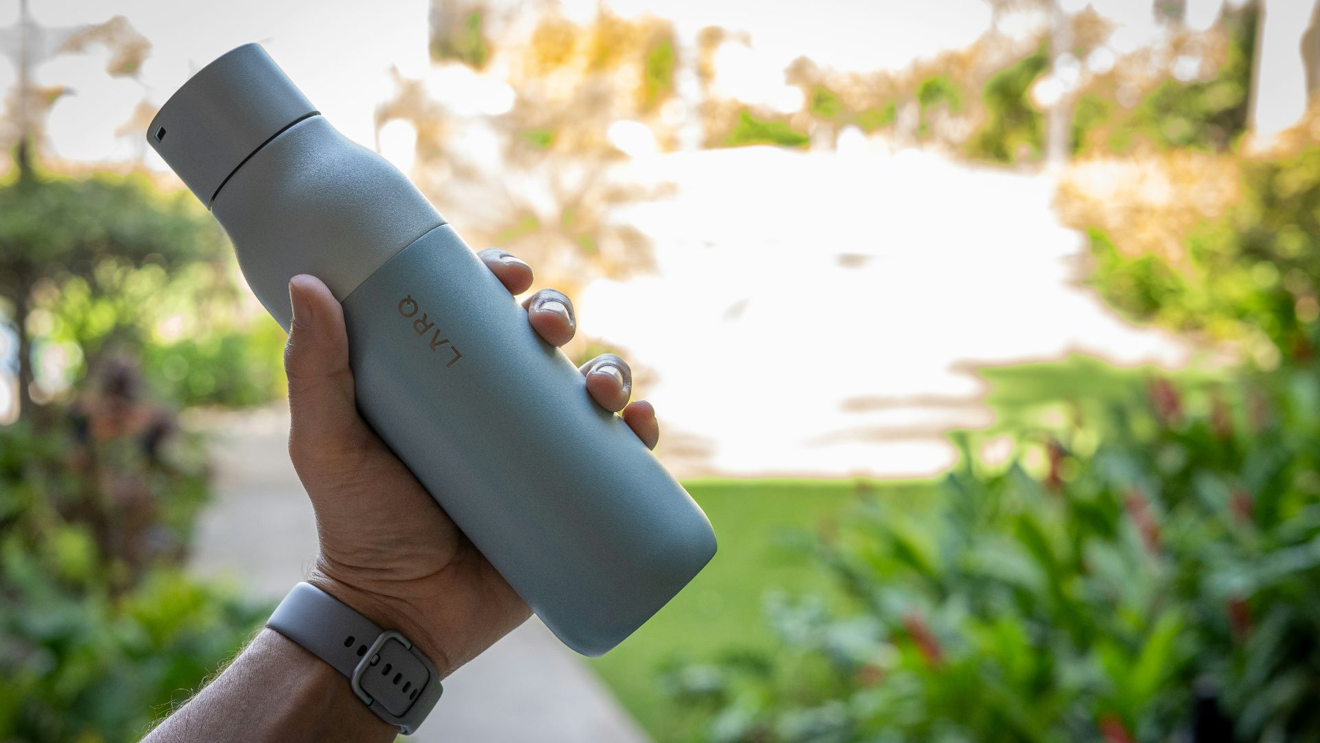person holding blue and white bottle