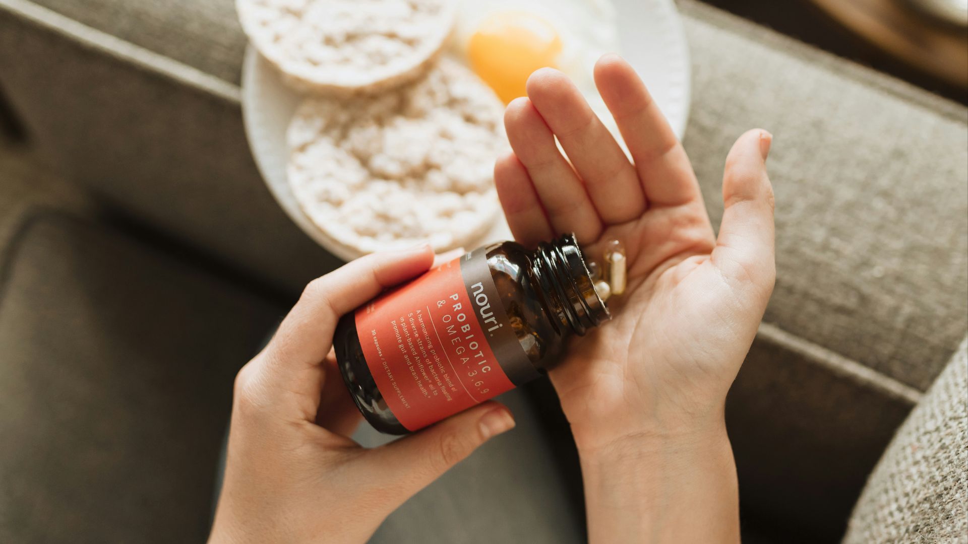 person holding red bottle