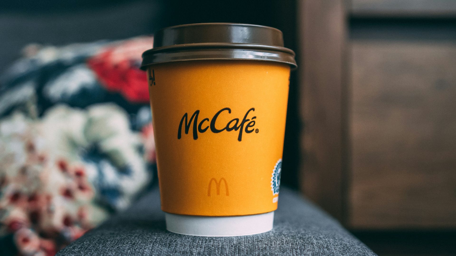 a cup of coffee sitting on top of a chair