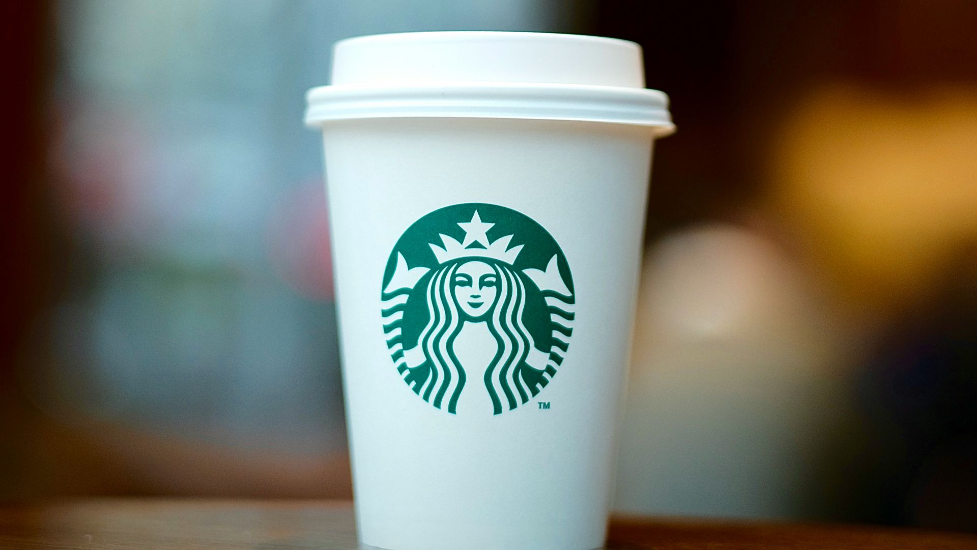 white and green starbucks disposable cup