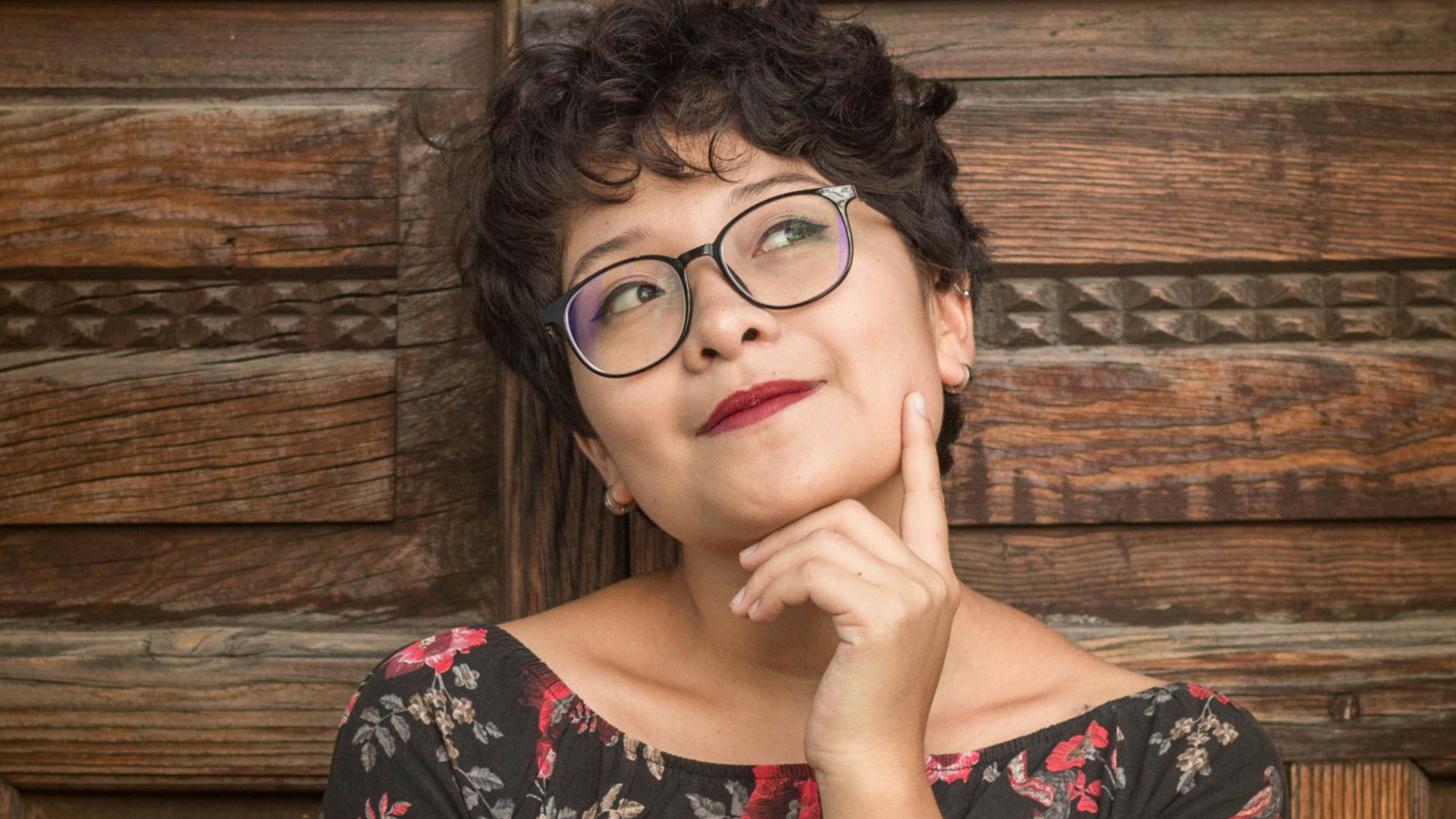 woman leaning against door while holding her cheek