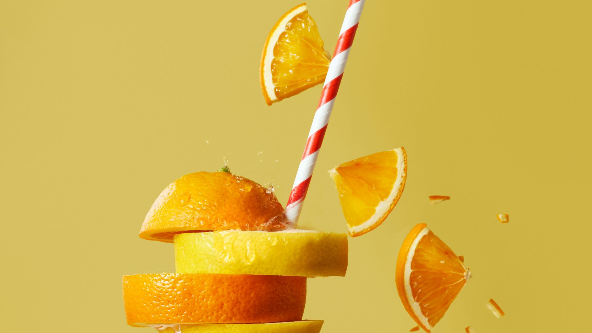 sliced orange fruit with straw