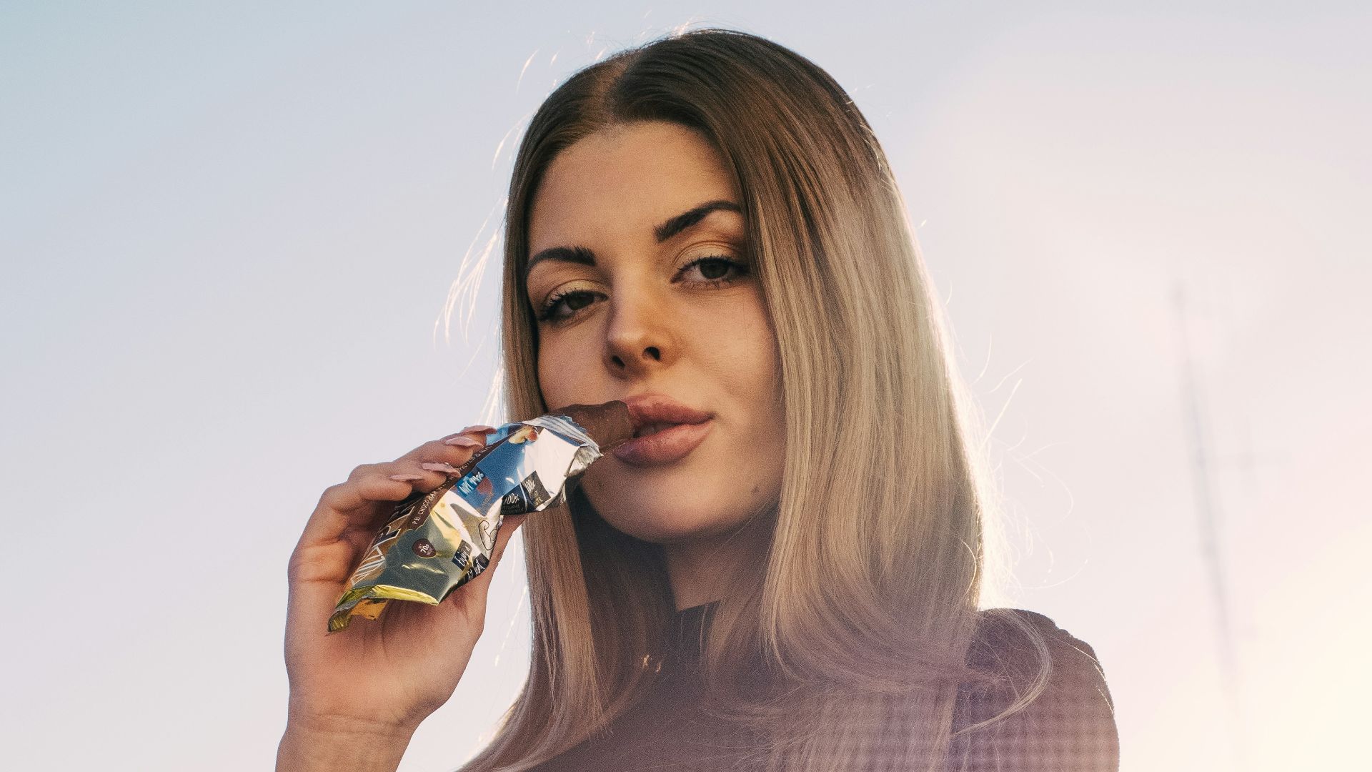 a woman in a black dress is talking on a cell phone