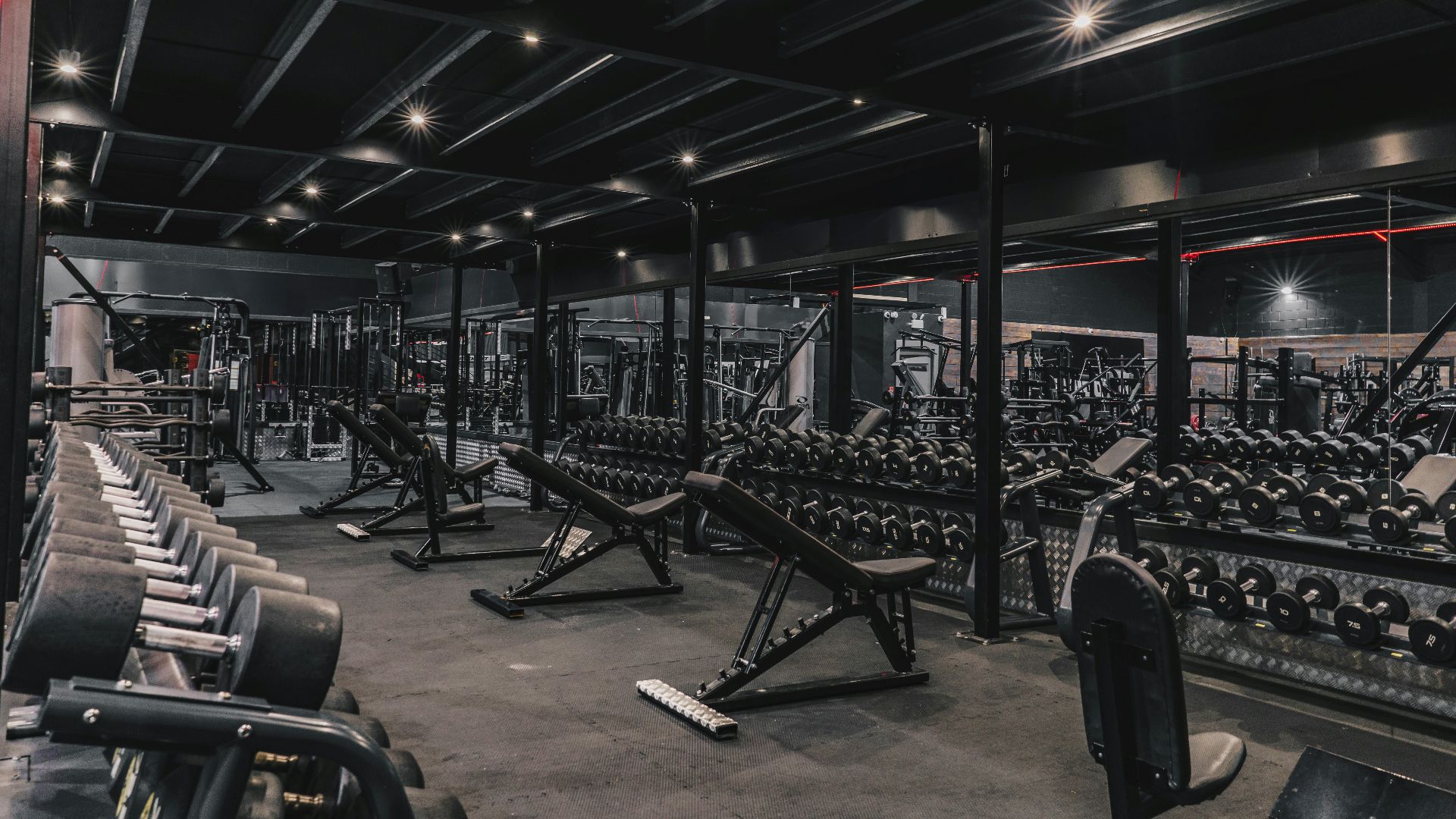 a gym filled with lots of machines and weights