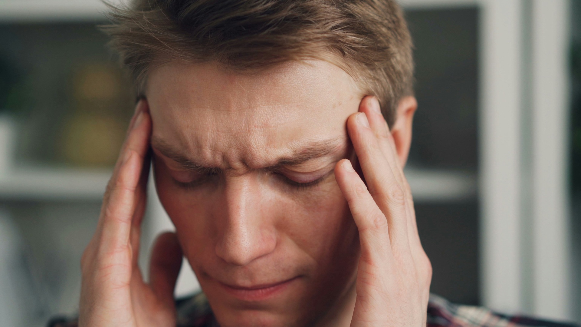 a man holding his hands to his ears