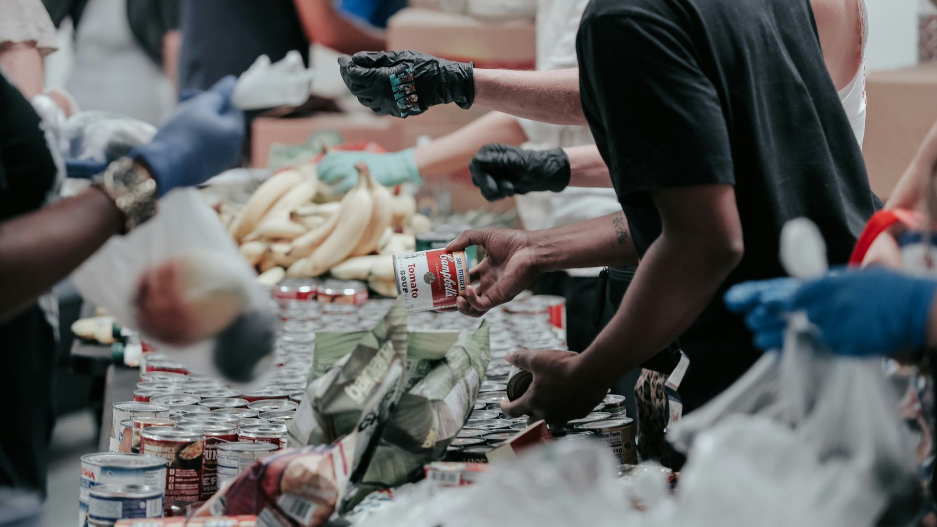 man in black t-shirt holding coca cola bottle