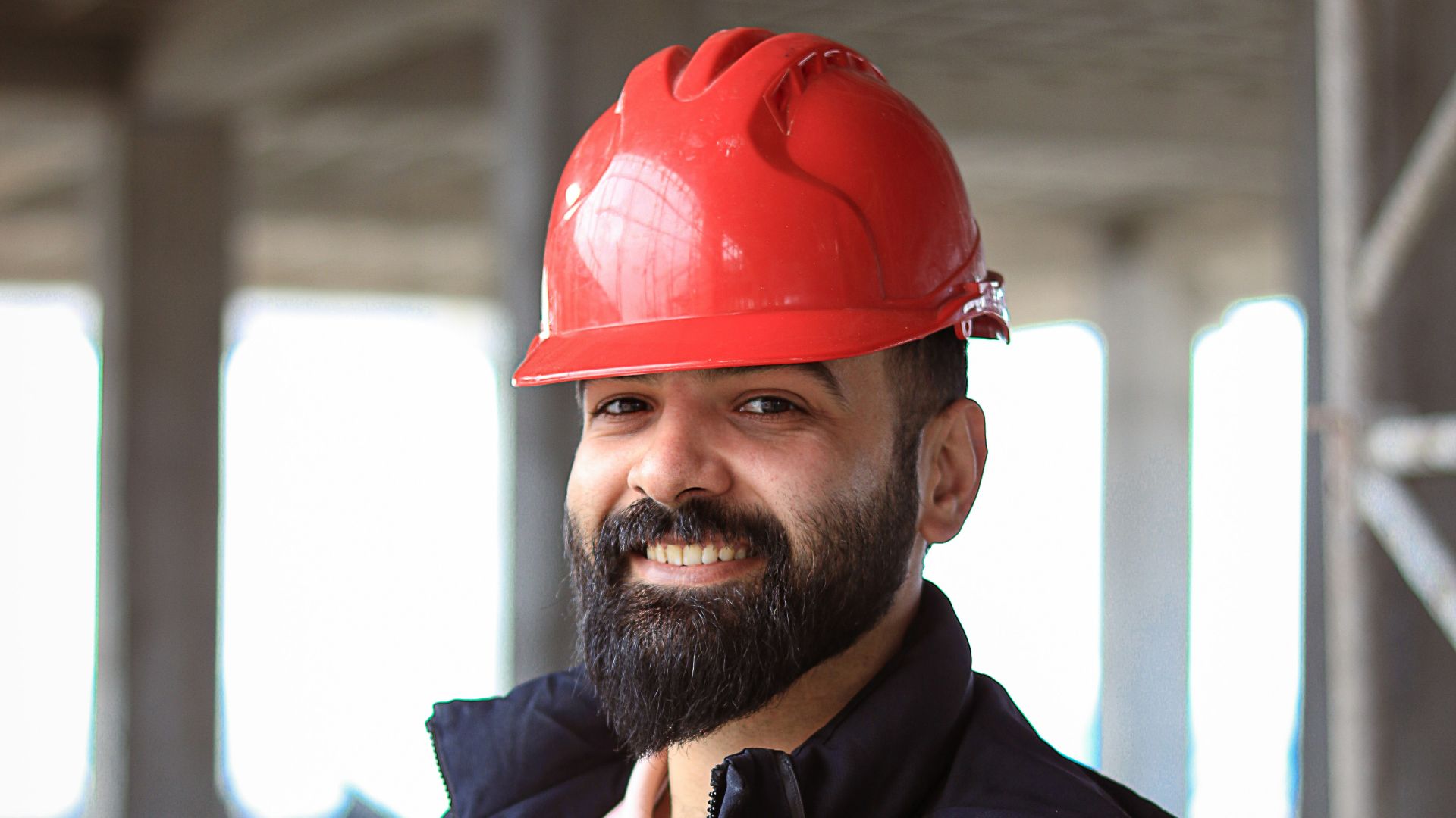 a man wearing a red hard hat and jacket