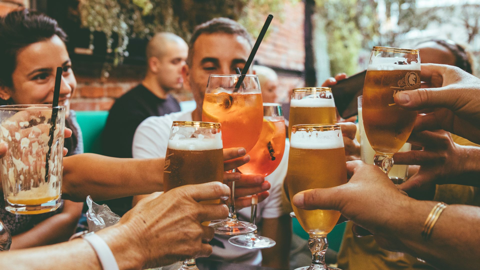 people holding drinks during day
