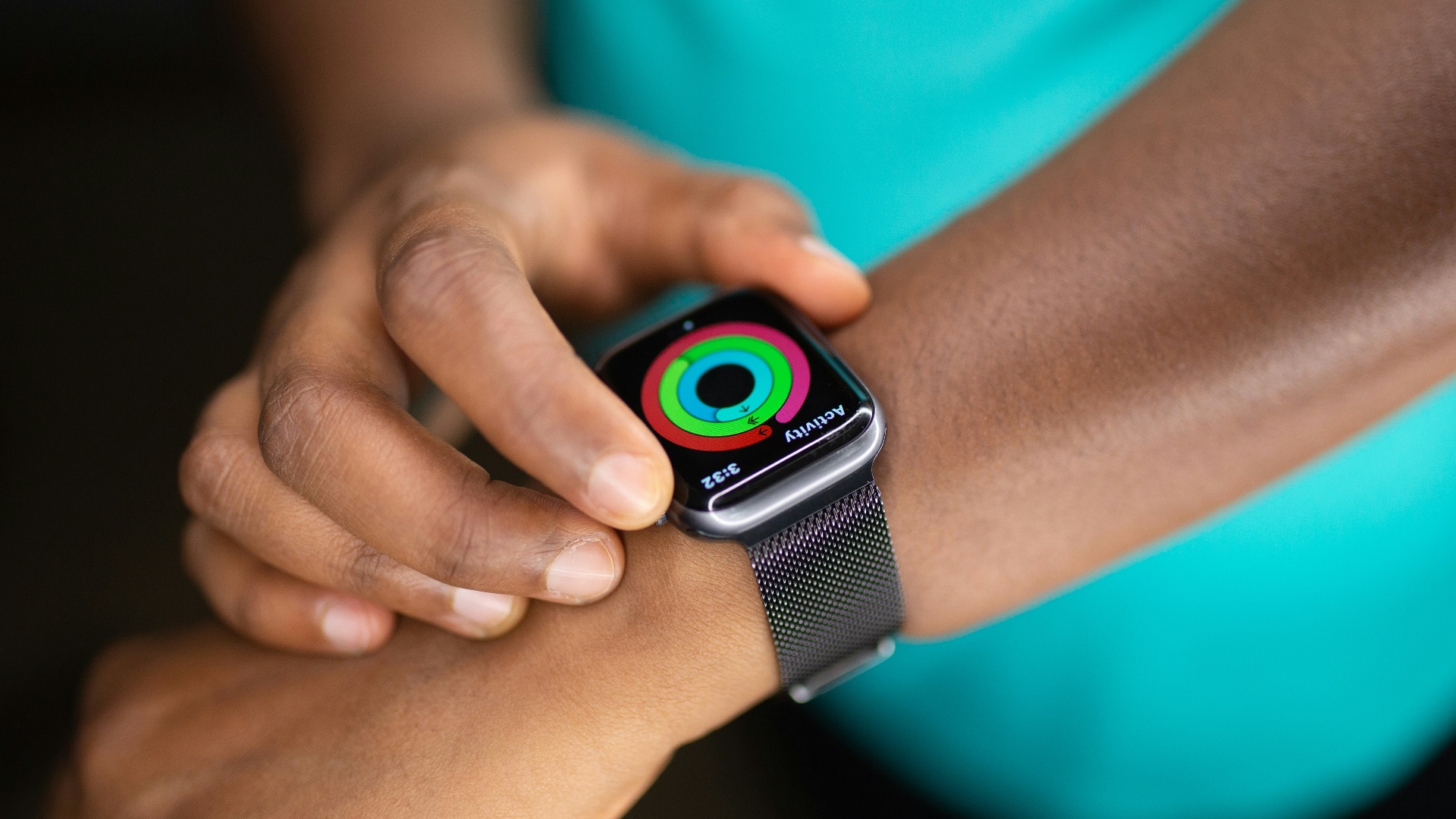 person wearing silver aluminum case apple watch with white sport band