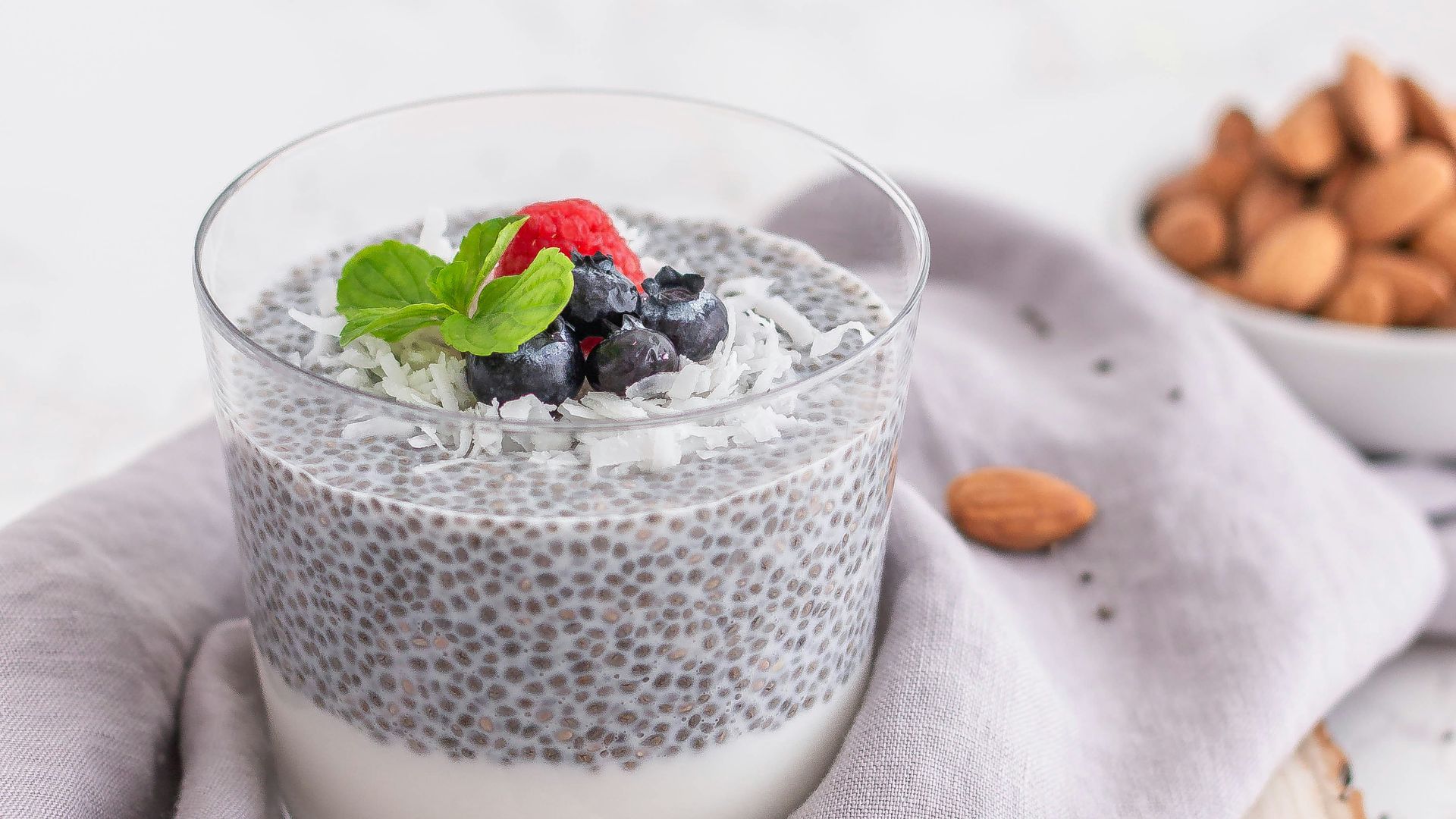 a glass of milk with berries and a spoon