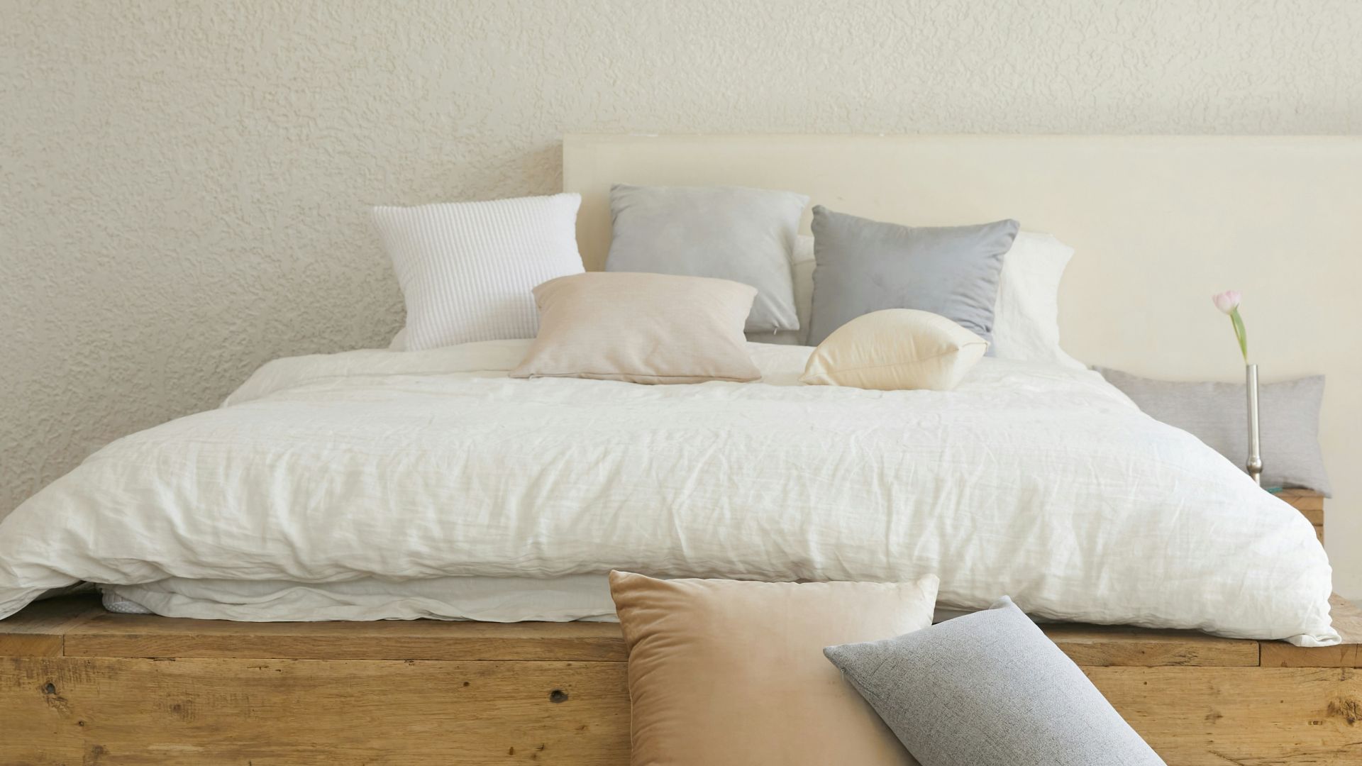 white bed pillow on brown wooden bed frame