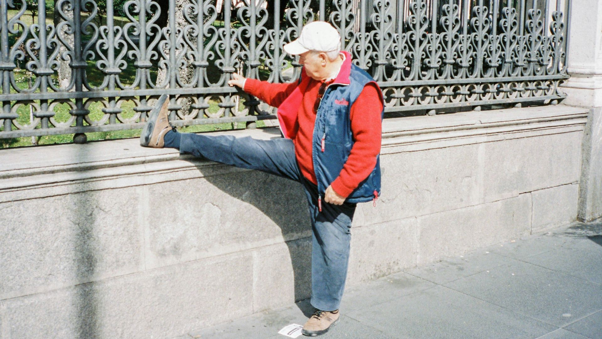 woman in blue jacket and blue denim jeans standing on gray concrete floor during daytime