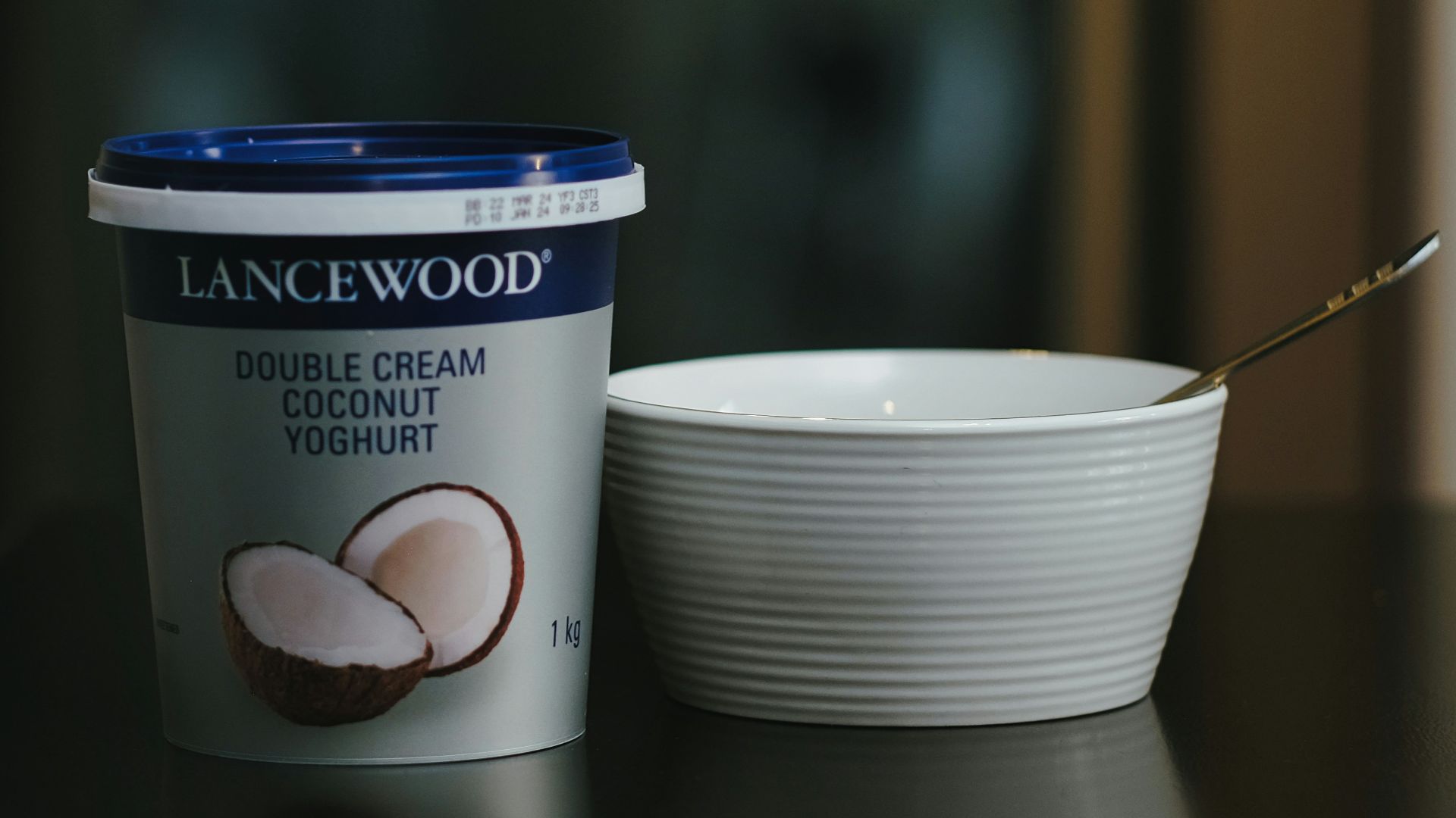 a cup of coffee next to a container of ice cream