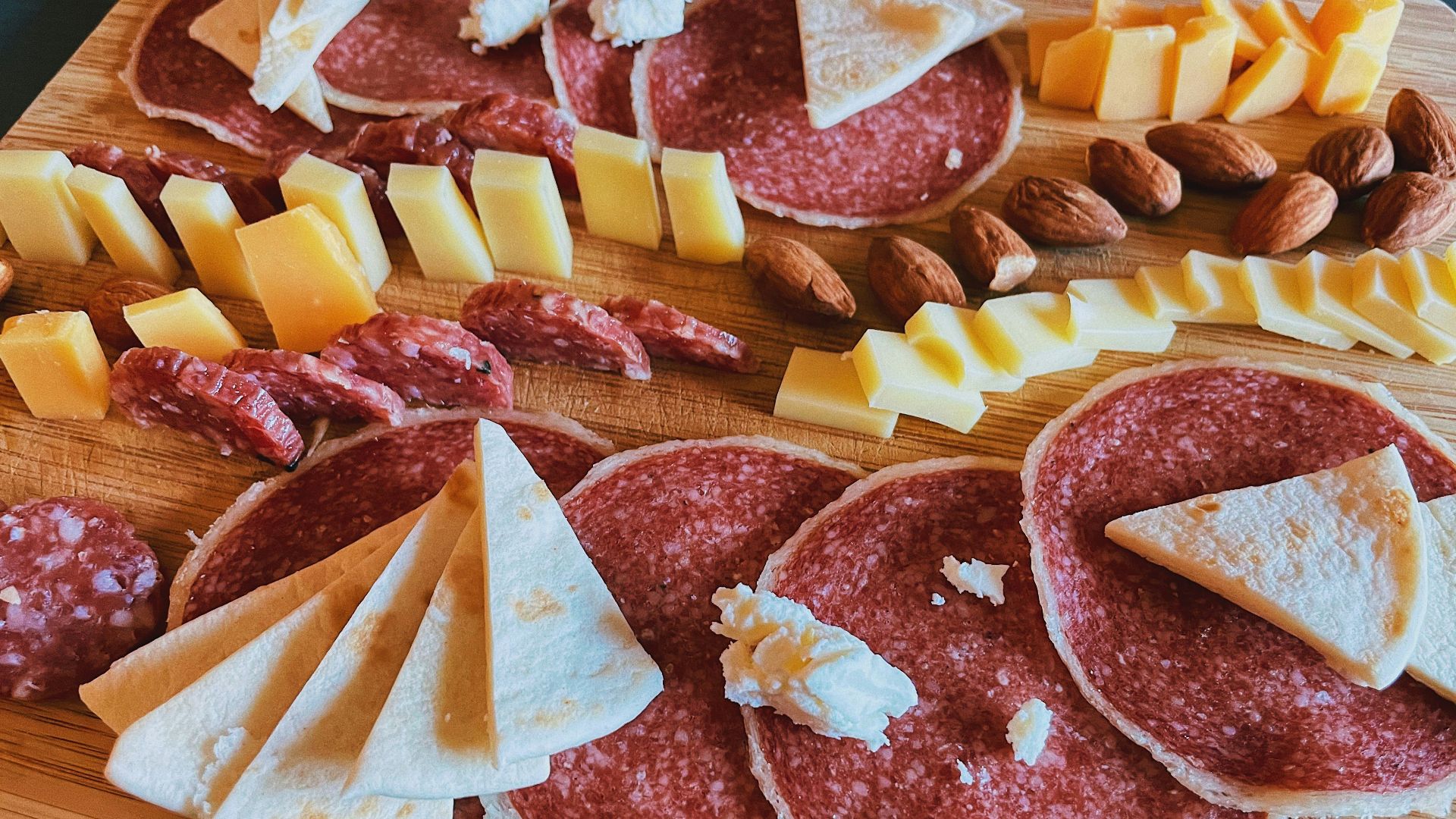 sliced meat on brown wooden chopping board