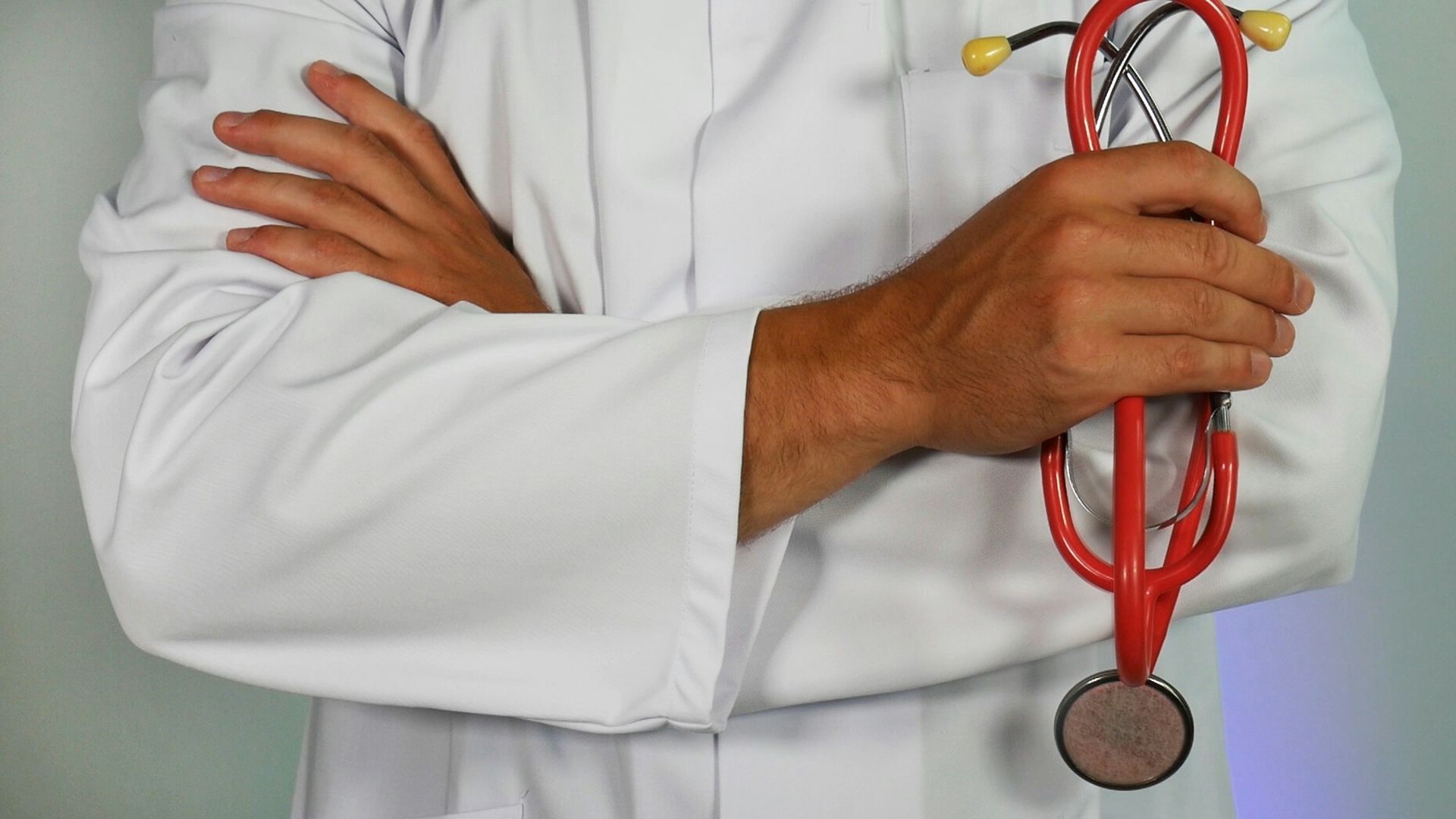 doctor holding red stethoscope
