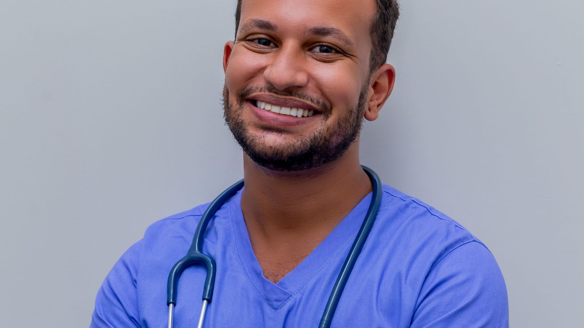 man in blue crew neck t-shirt smiling