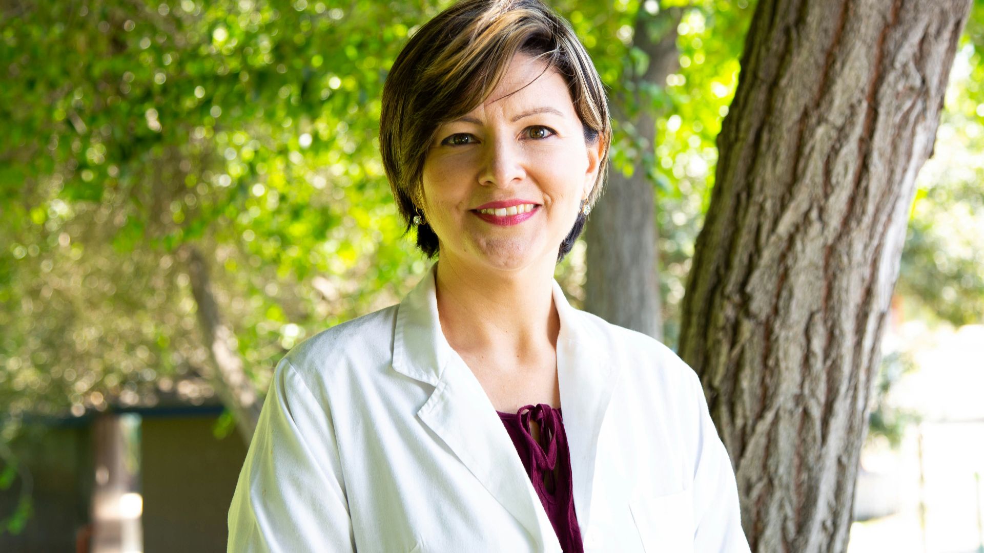 woman standing under tree