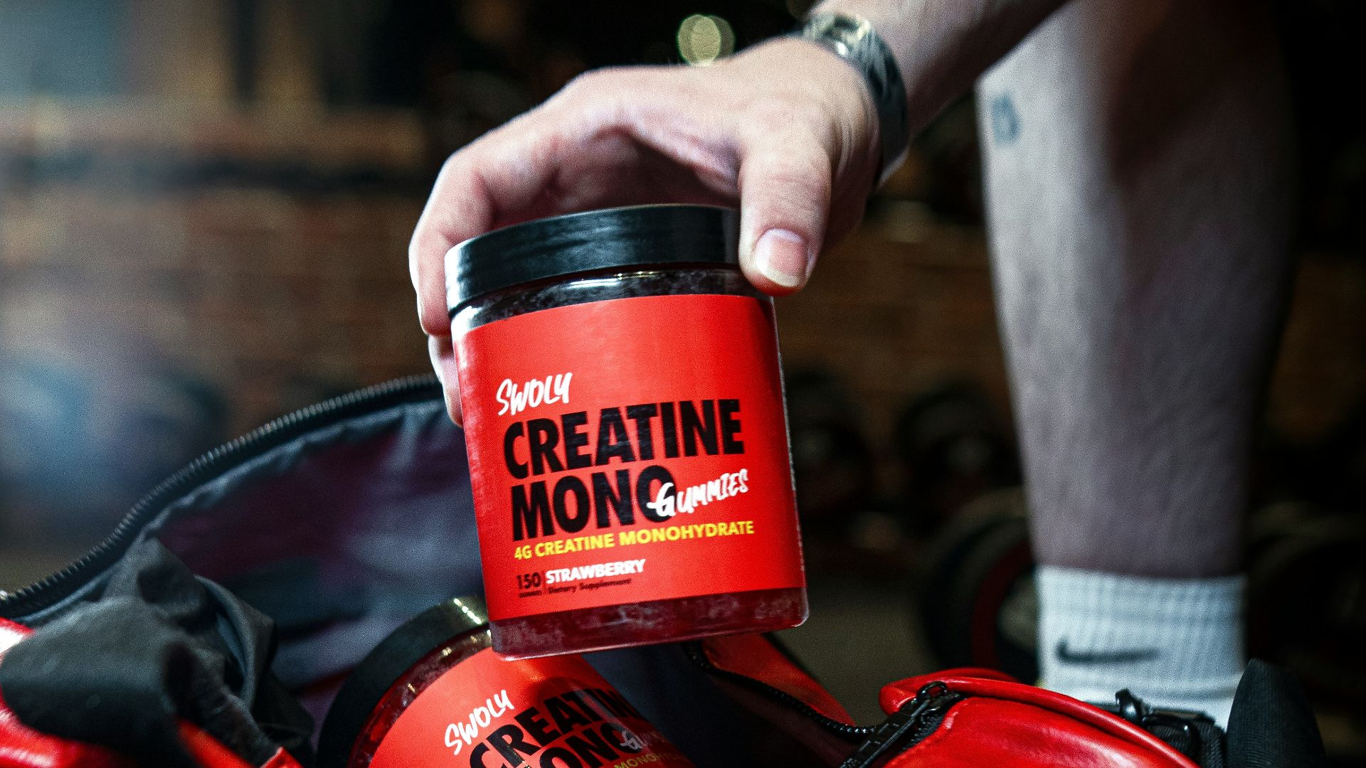 a man is holding a cup of coffee in a duffel bag